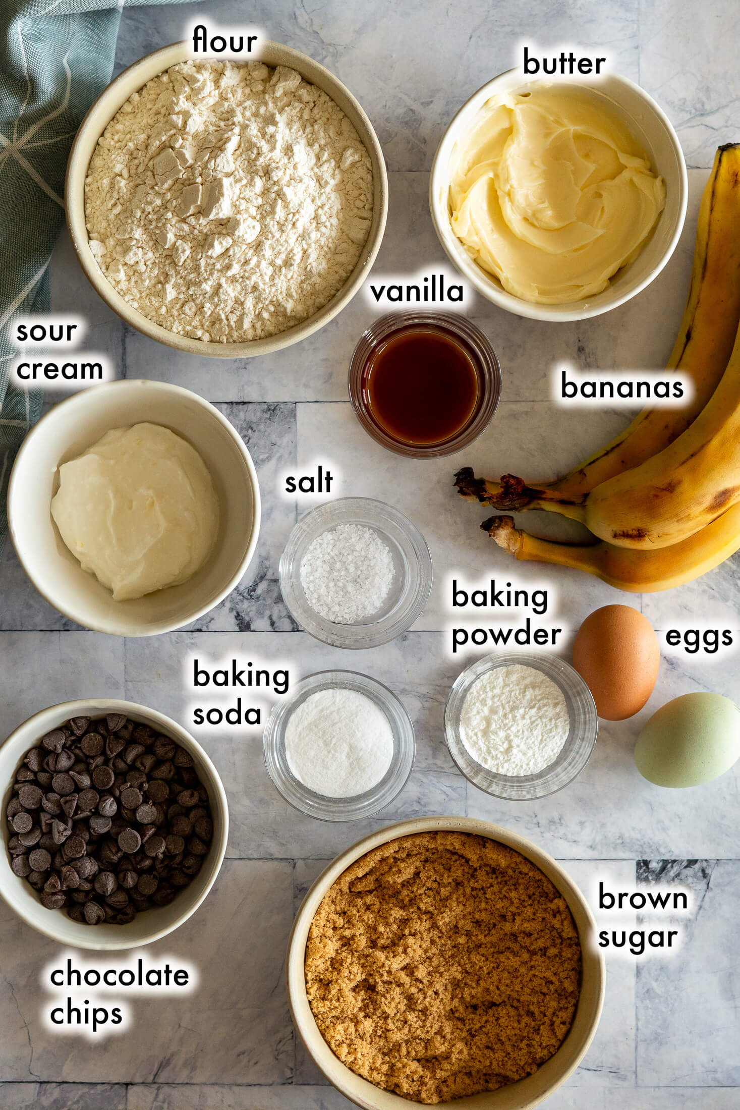 Ingredients required for bread machine banana bread, including bananas, sour cream, and brown sugar. 