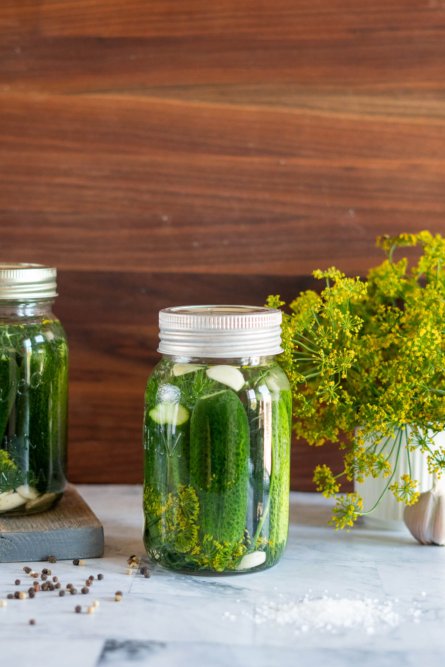 Half sour pickles in a jar.