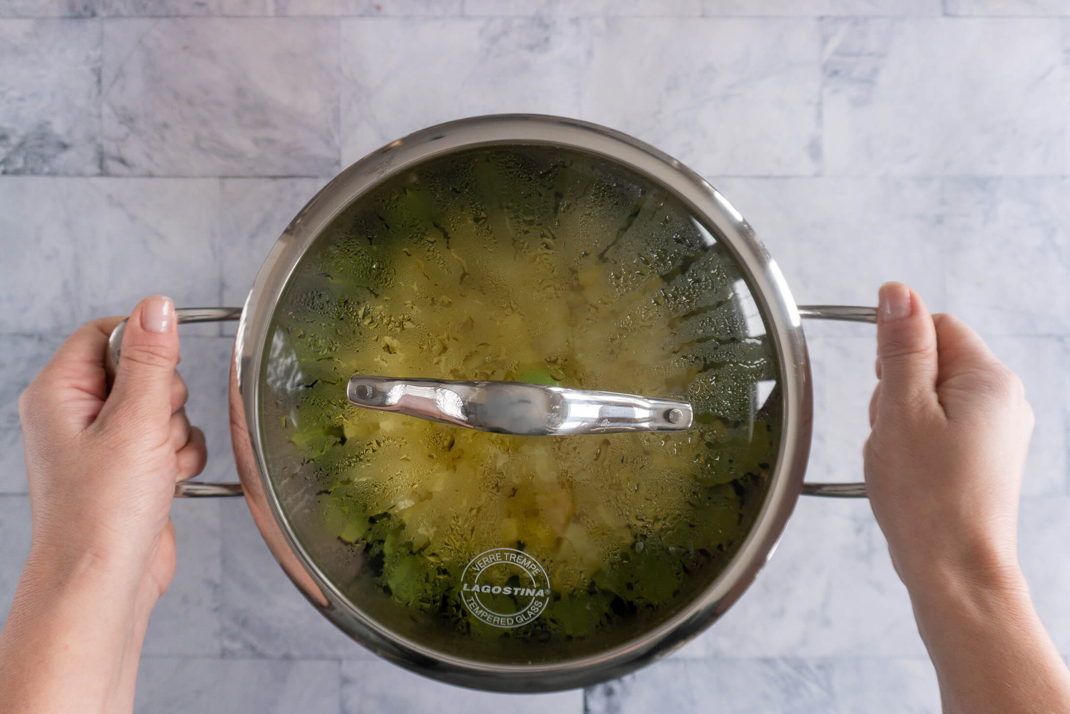 Steamed diced potatoes in a covered pot. 