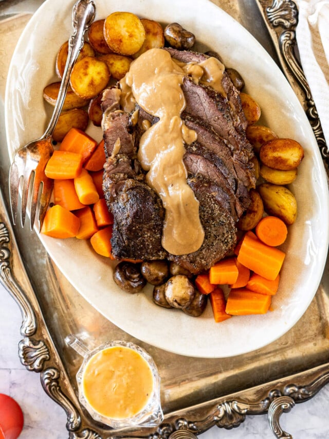 Sliced cross rib roast on a serving platter.