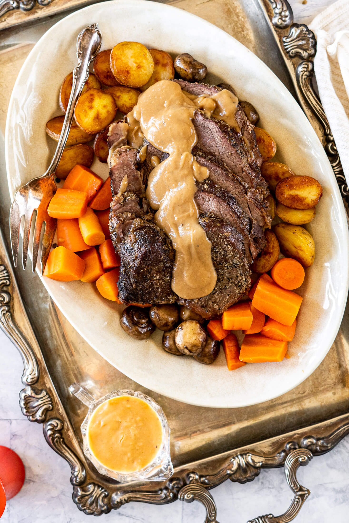 Sliced cross rib roast on a serving platter.