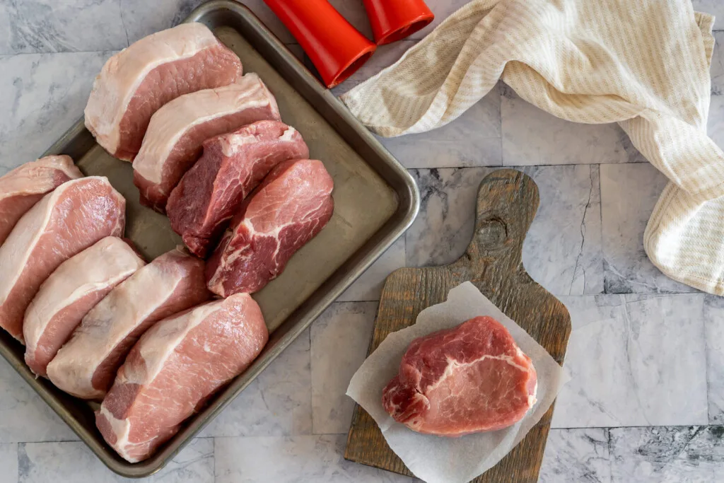 Raw pork chops ready to be frozen.
