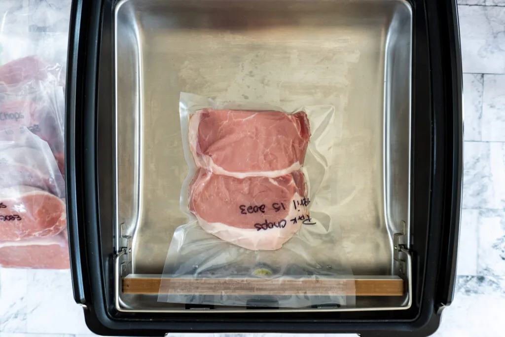 Vacuum sealed pork chops in Avid Armor chamber vacuum sealer.