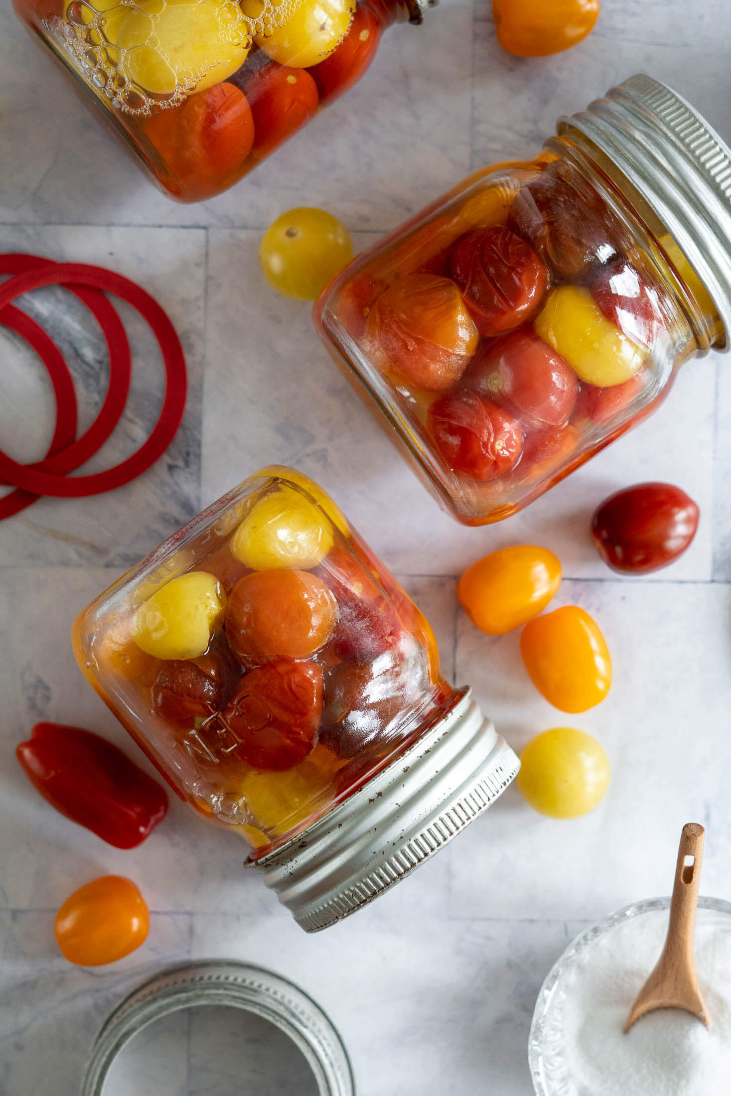 Canned cherry tomatoes in vintage jars.