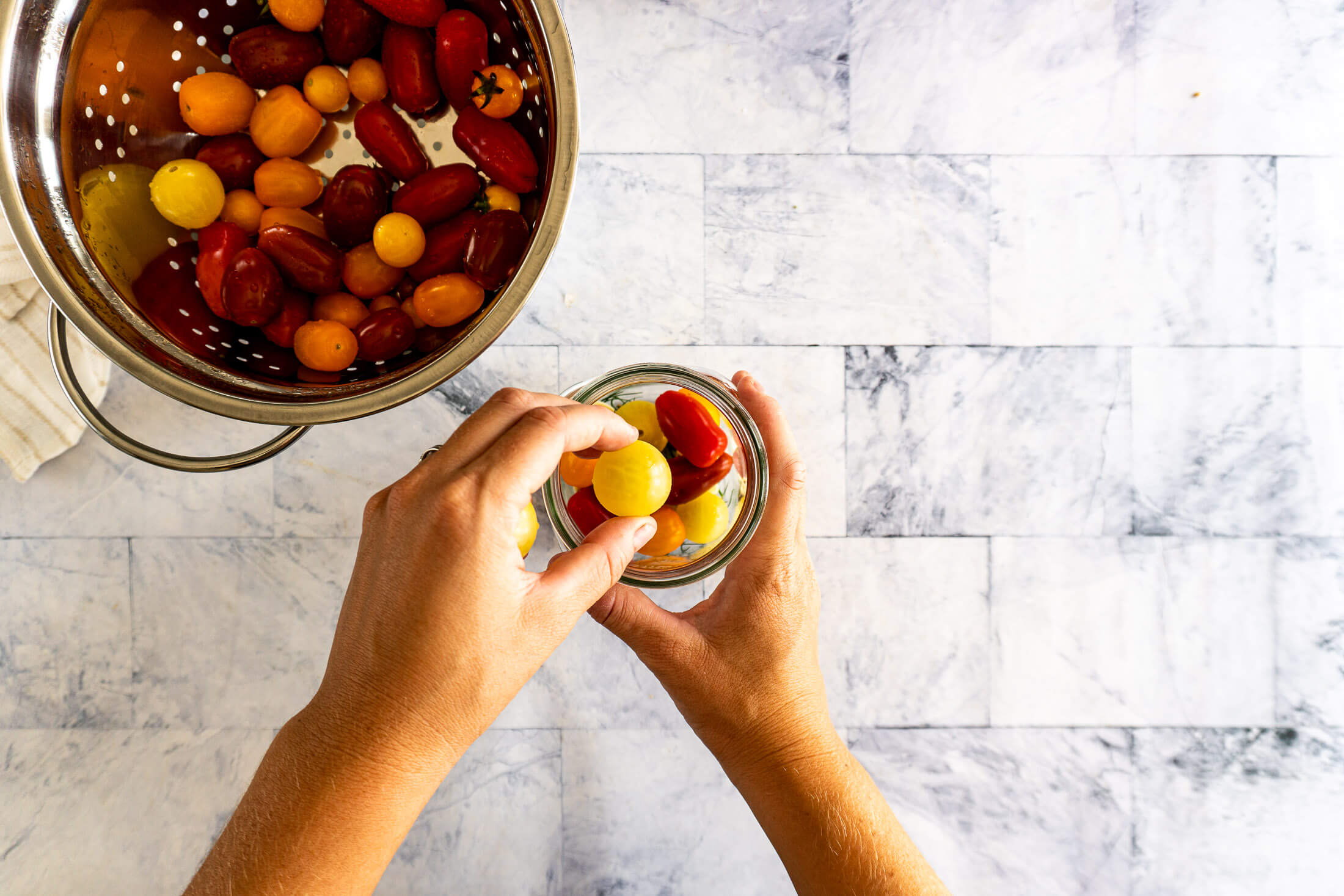 Packing tomatoes into fermenting jar. 