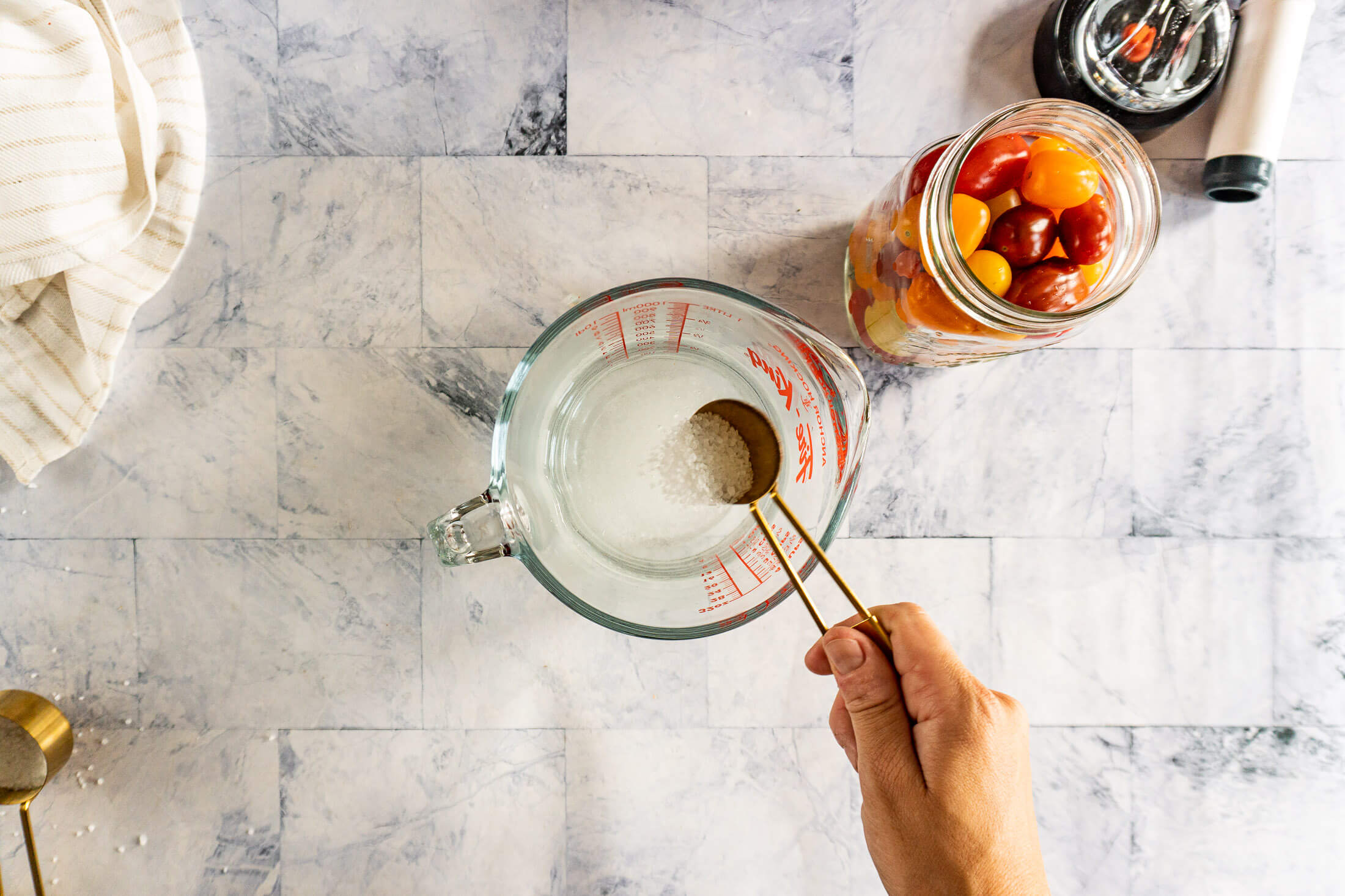 Adding salt to brine. 