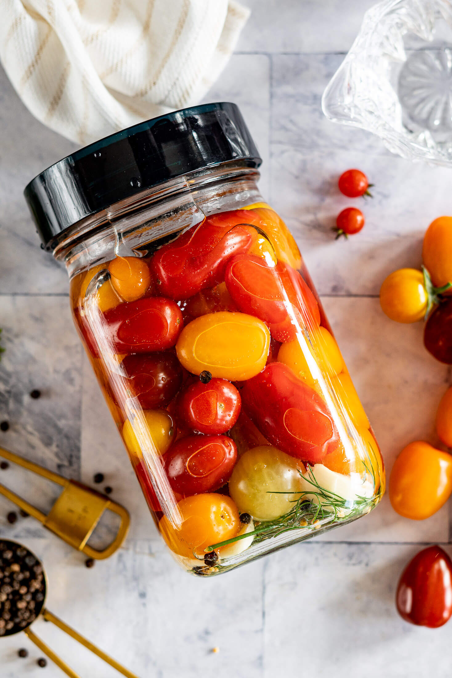 Fermented cherry tomatoes in a mason jar with an airlock lid. 