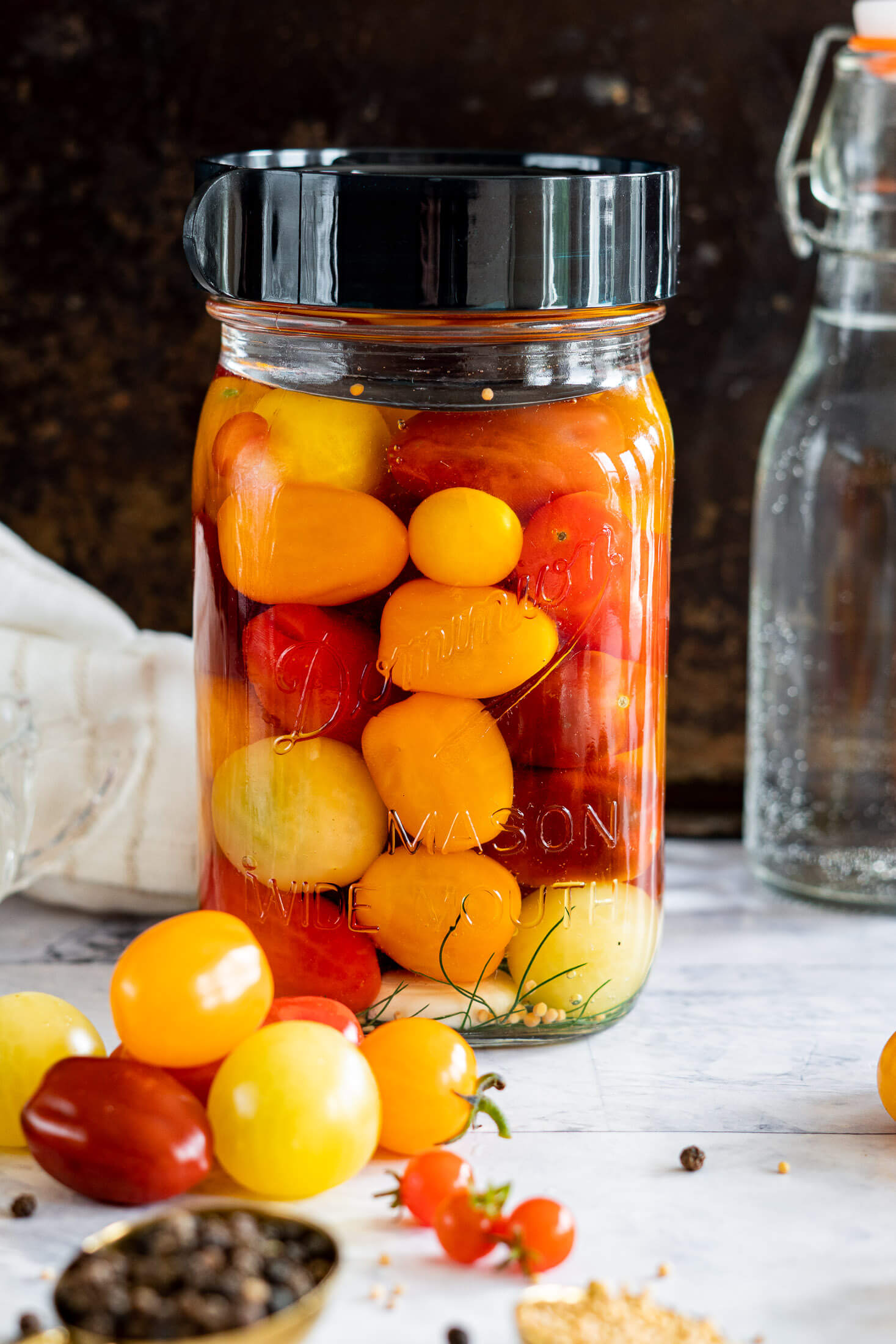 Fermented cherry tomatoes in a sealed jar with an airlock lid. 
