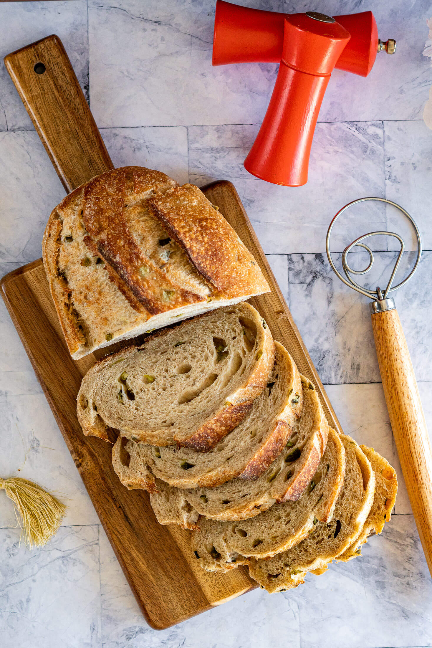 Close-up of pickle juice sourdough bread crumb, showing the caramel-brown crust and pickle inclusions.