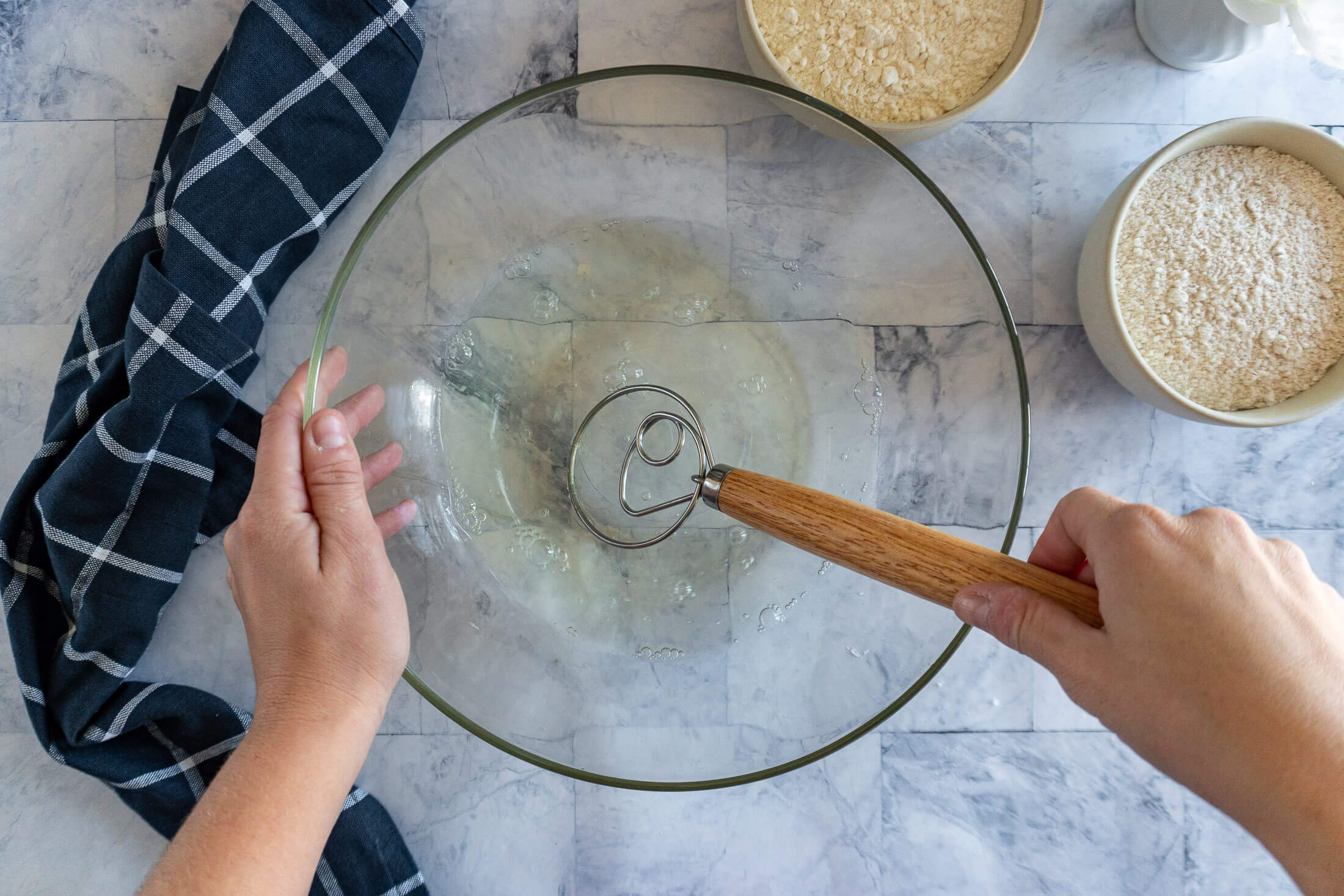 Whisking honey into warm water with danish dough whisk.