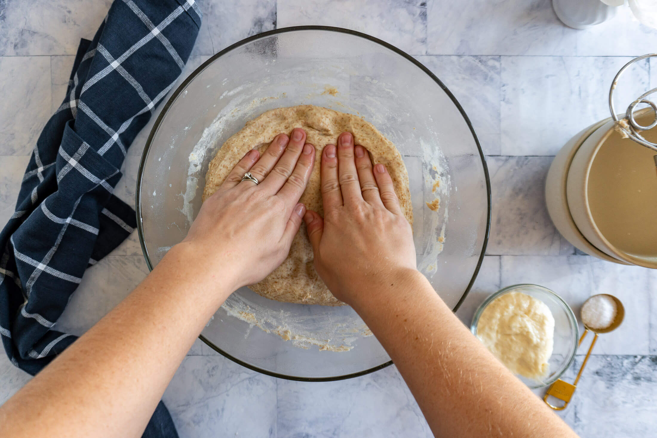 Patting the dough out in the bowl.
