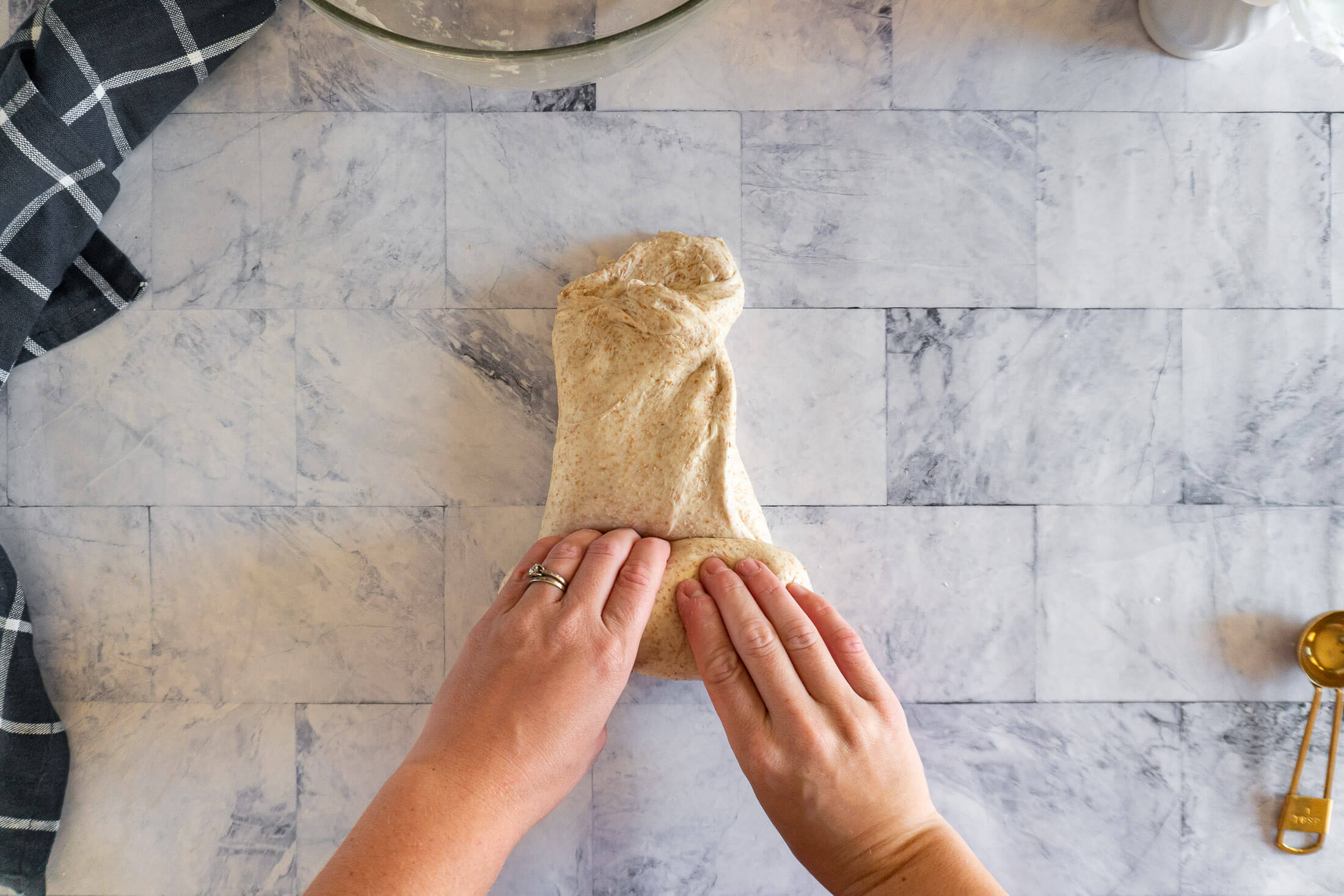 Rolling the folded dough into a log.