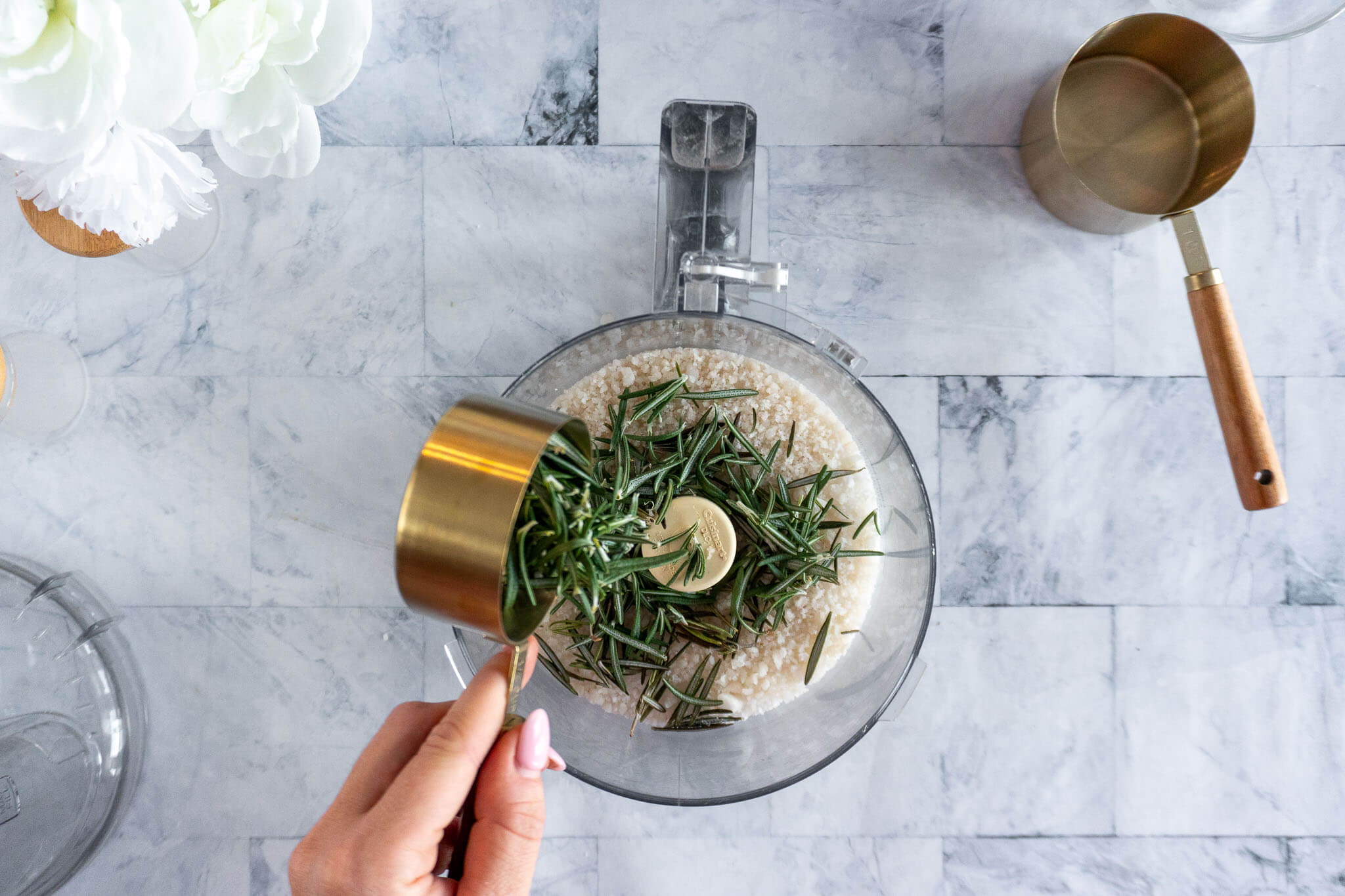 Adding rosemary to food processor.