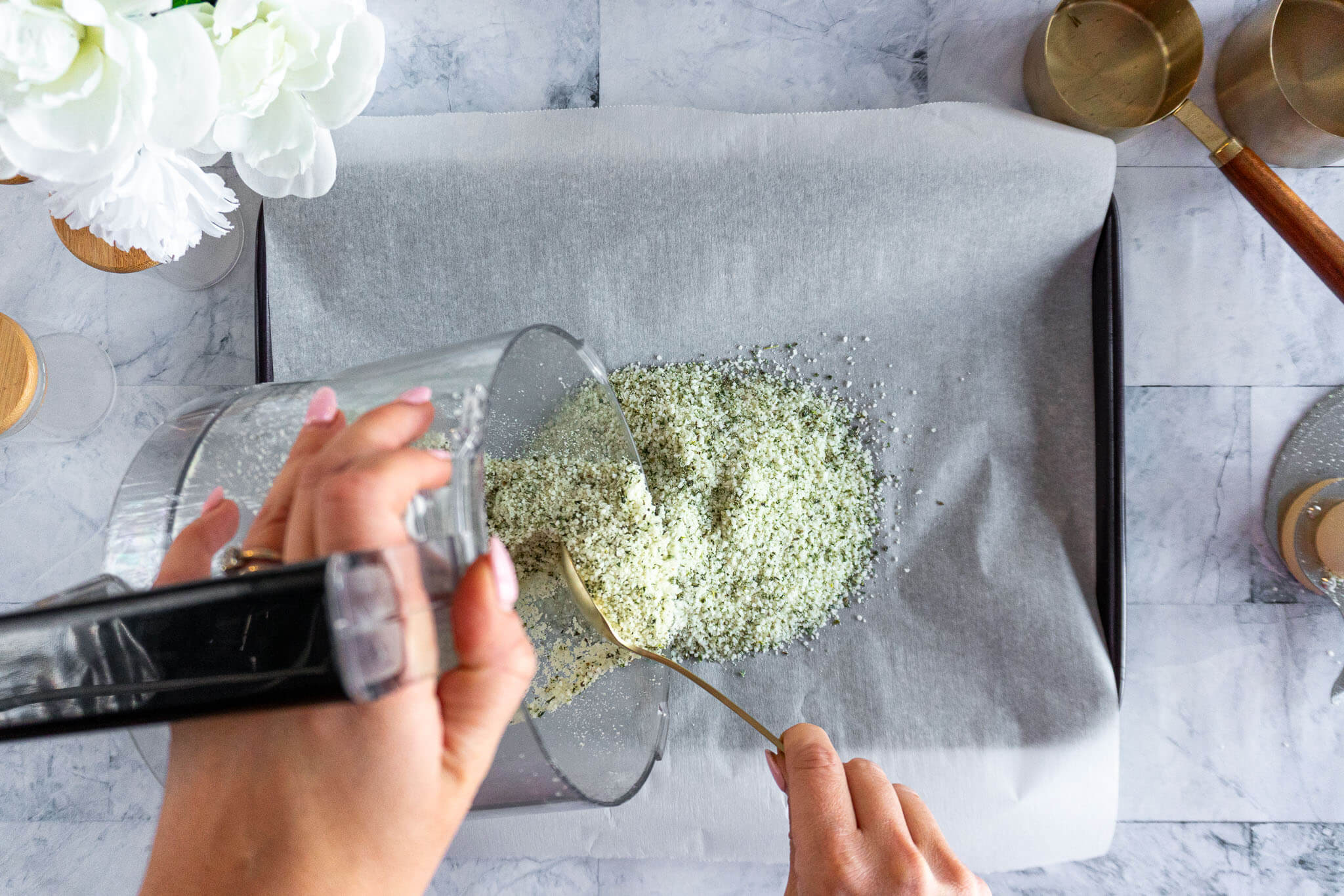 Dumping salt mixture onto baking sheet.