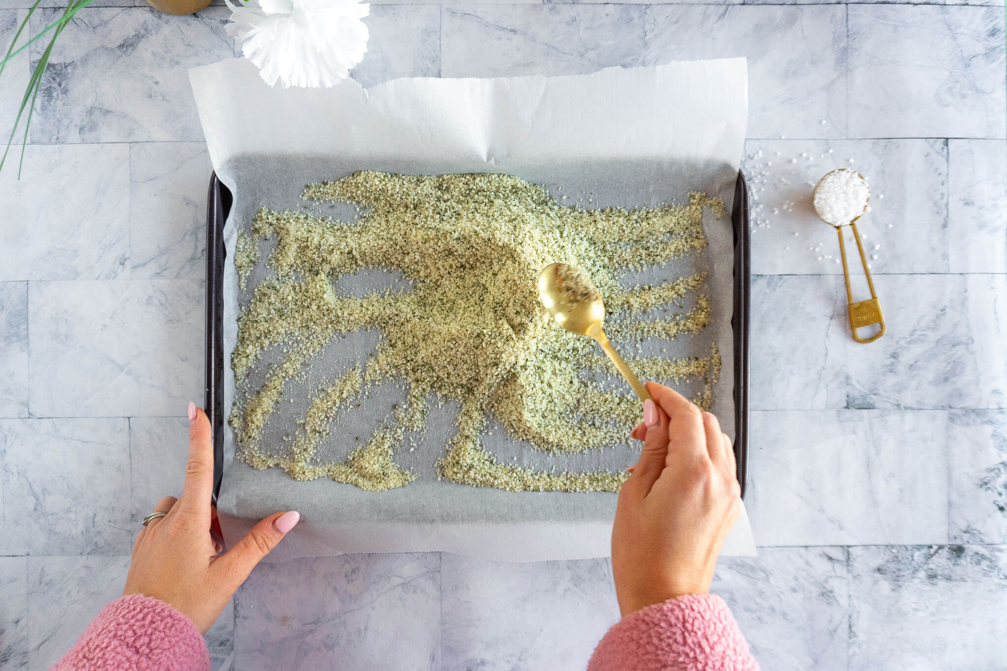 Stirring rosemary salt during drying time.