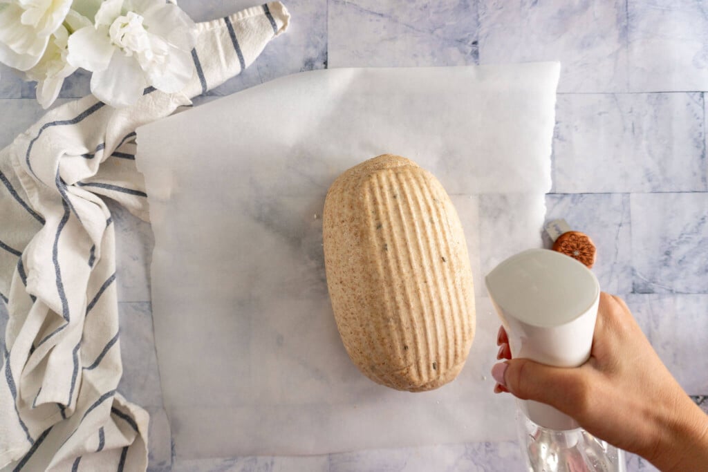 Spritzing dough with water. 