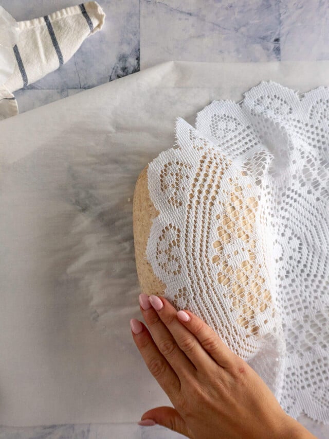 Pressing doily into dough.