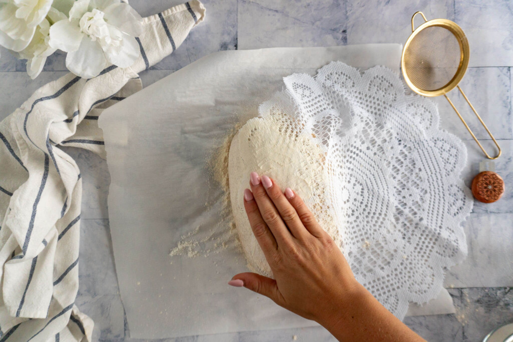 Patting flour into dough. 
