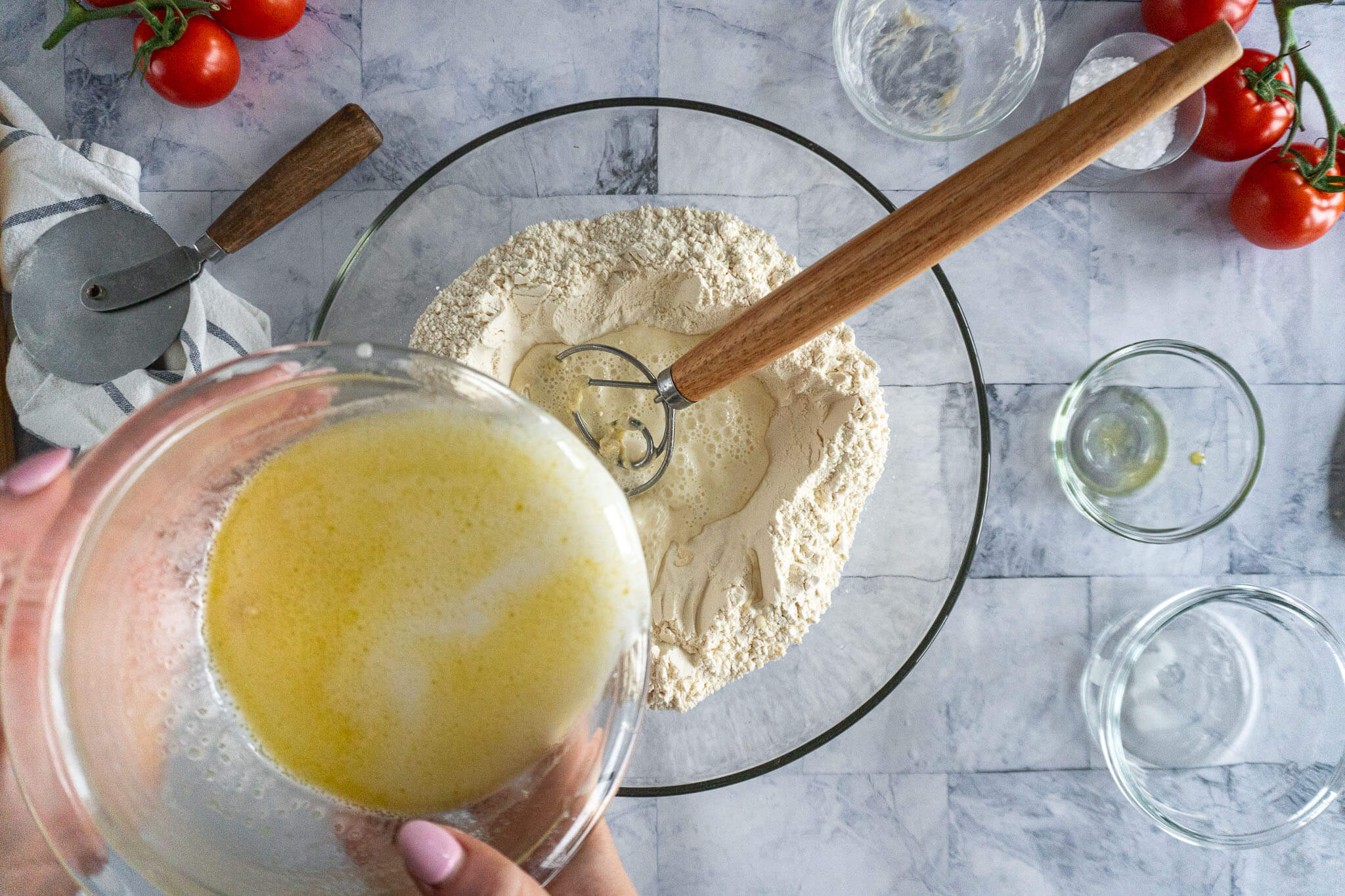 Adding wet ingredients to dry.