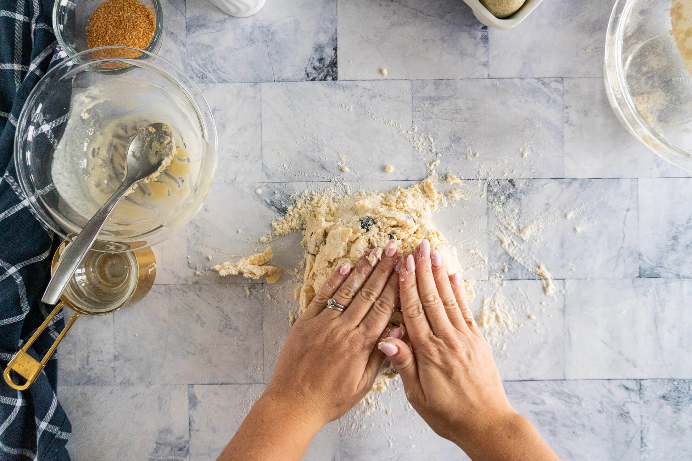 Gently pressing the dough together.