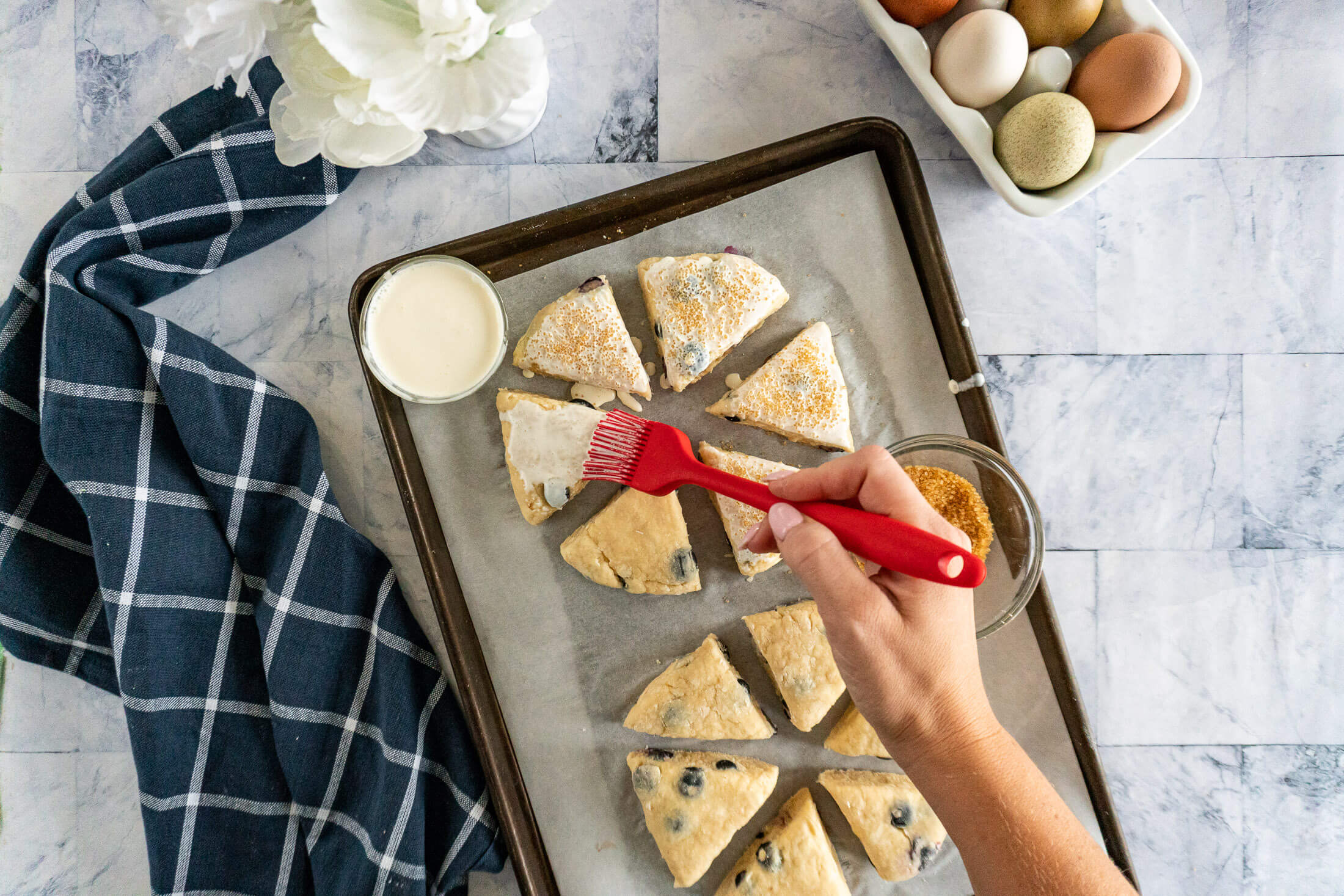 Brushing scones with heavy cream.
