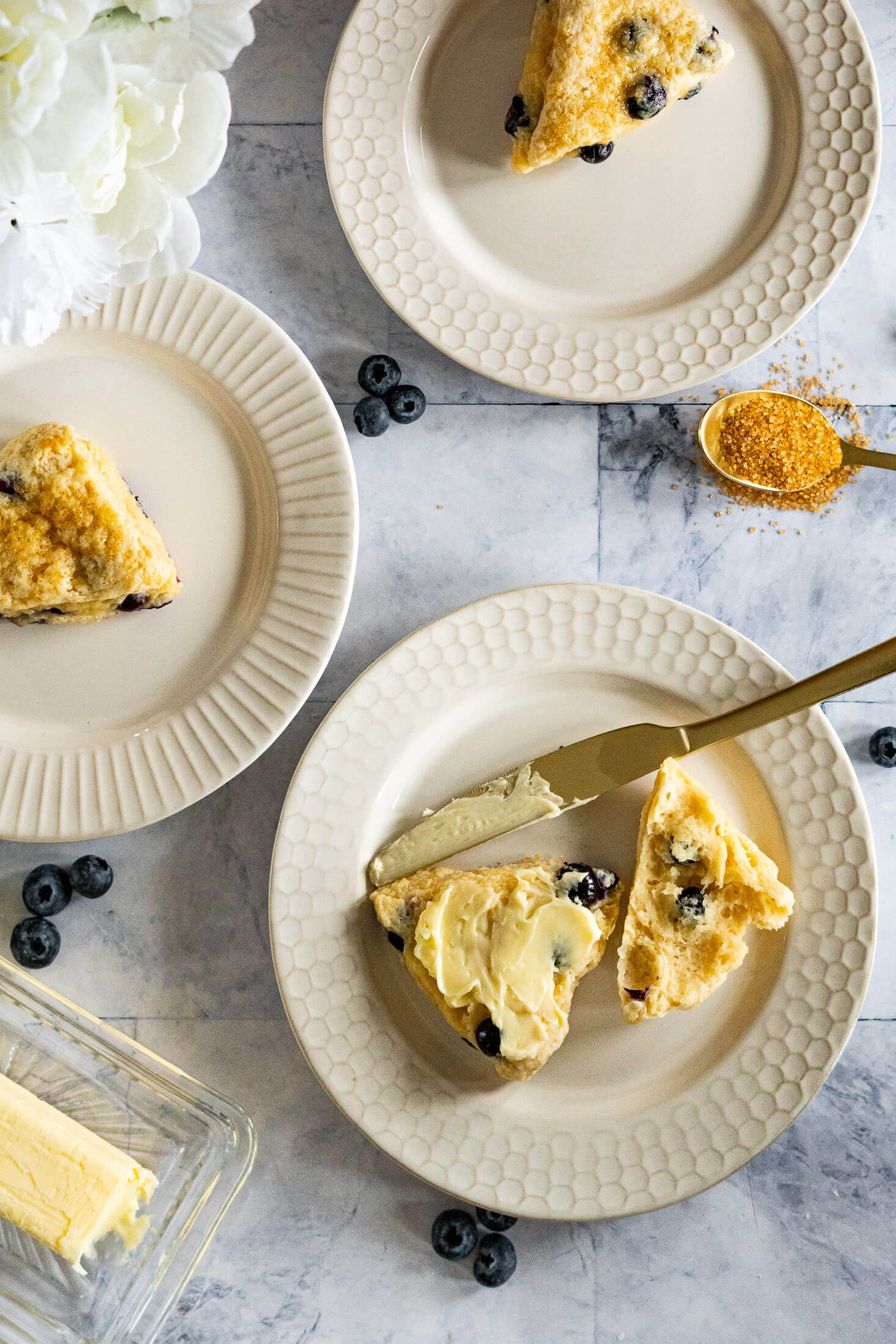 Scones on decorative cream colored plates.