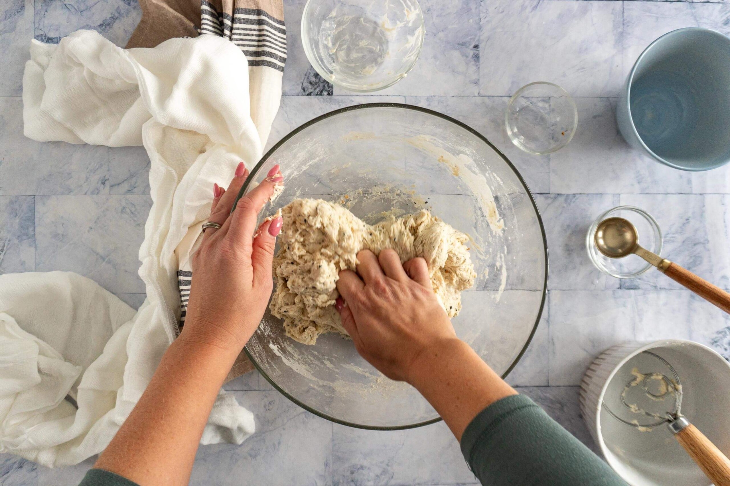 Kneading any dry bits into the dough. 