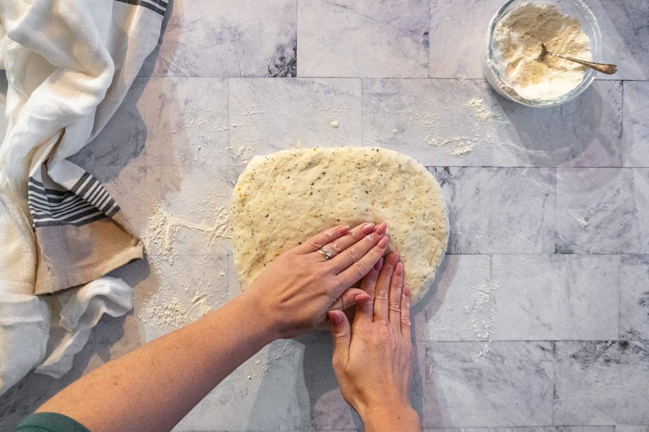Pressing the everything bagel dough into a rectangle. 