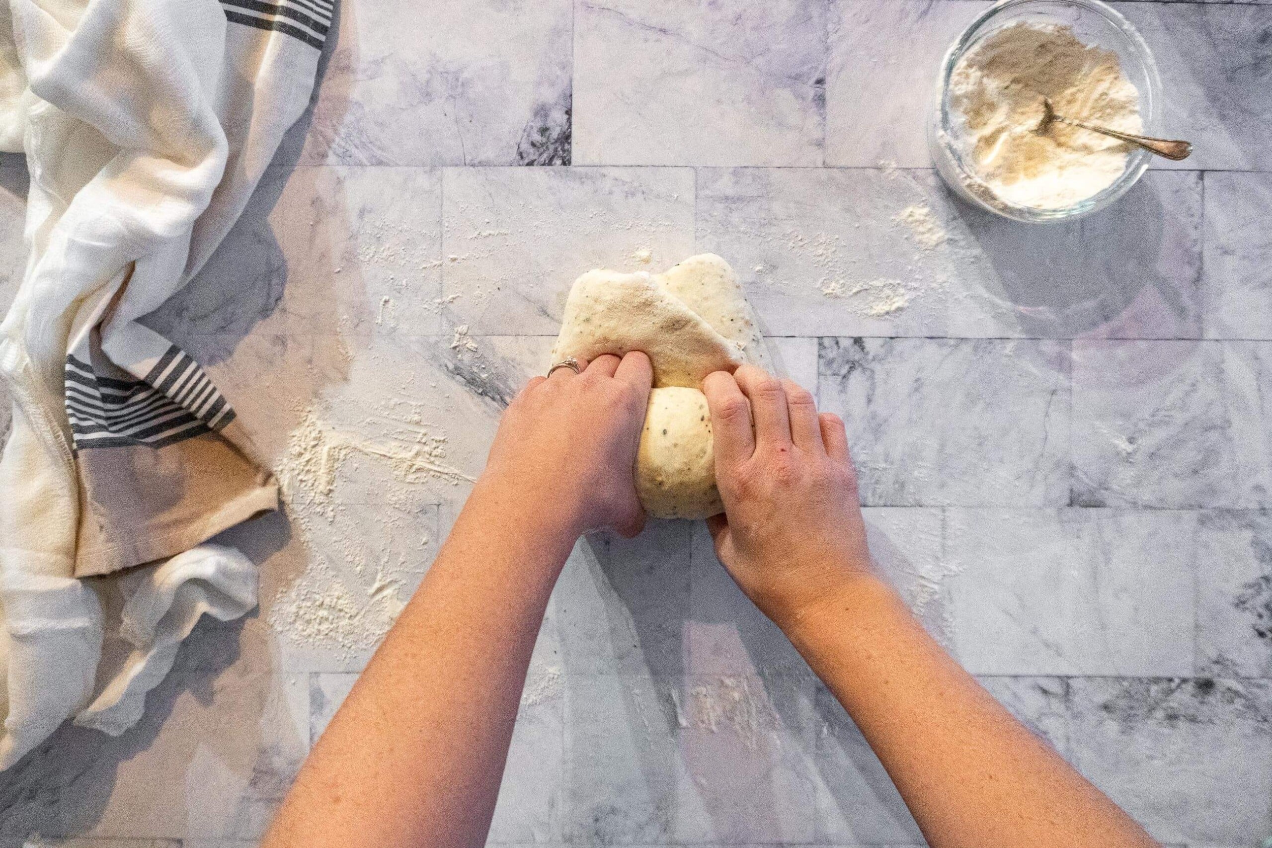 Rolling the dough into a log or batard. 