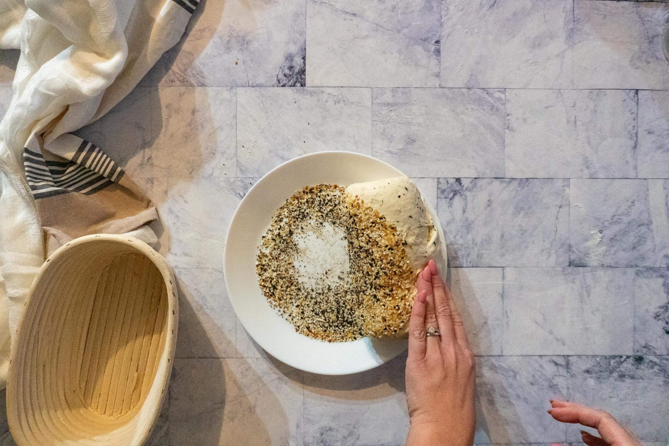 Rolling the dough in everything bagel seasoning. 