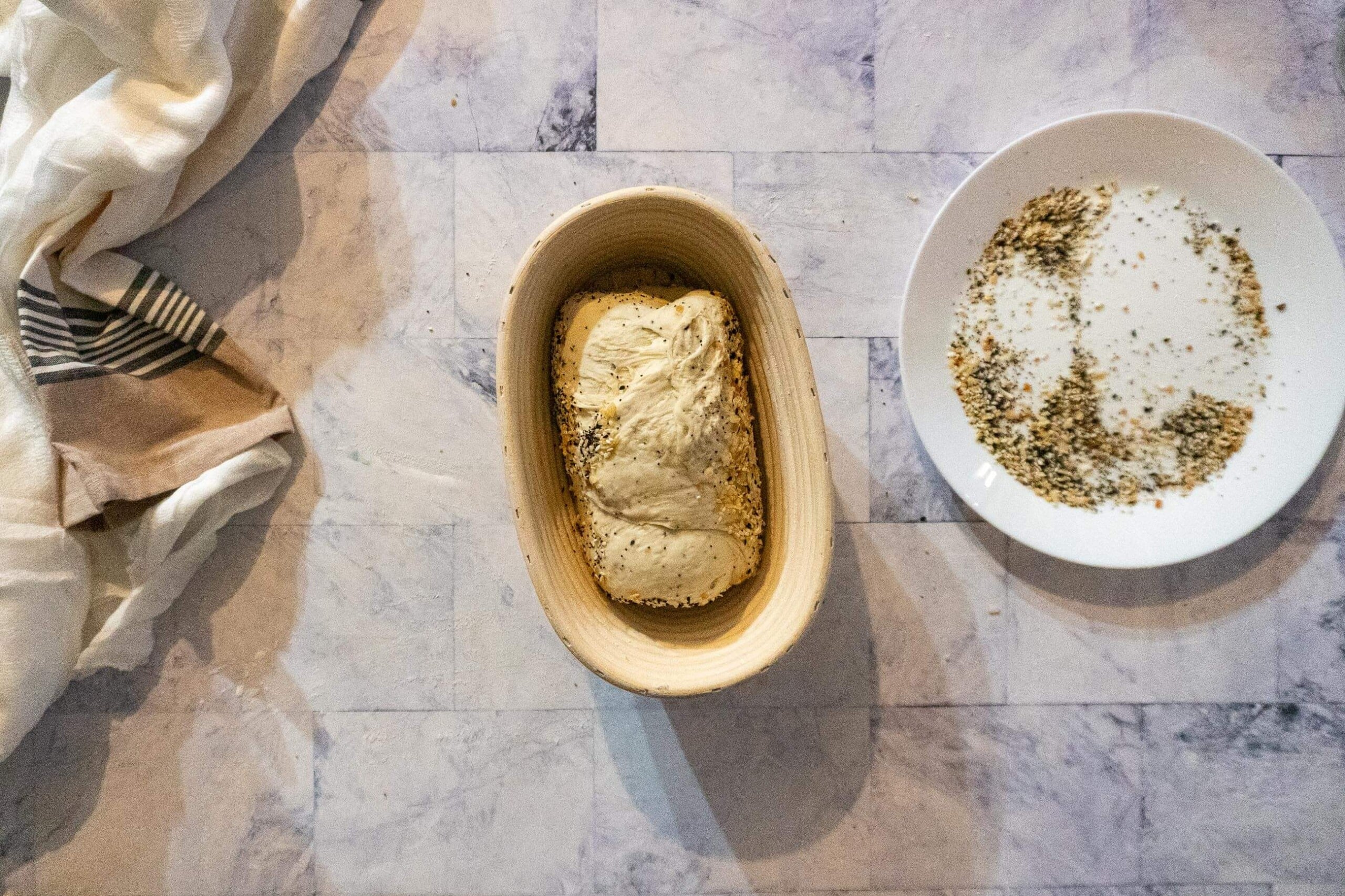 Dough after being rolled in seasoning, then placed in banneton.