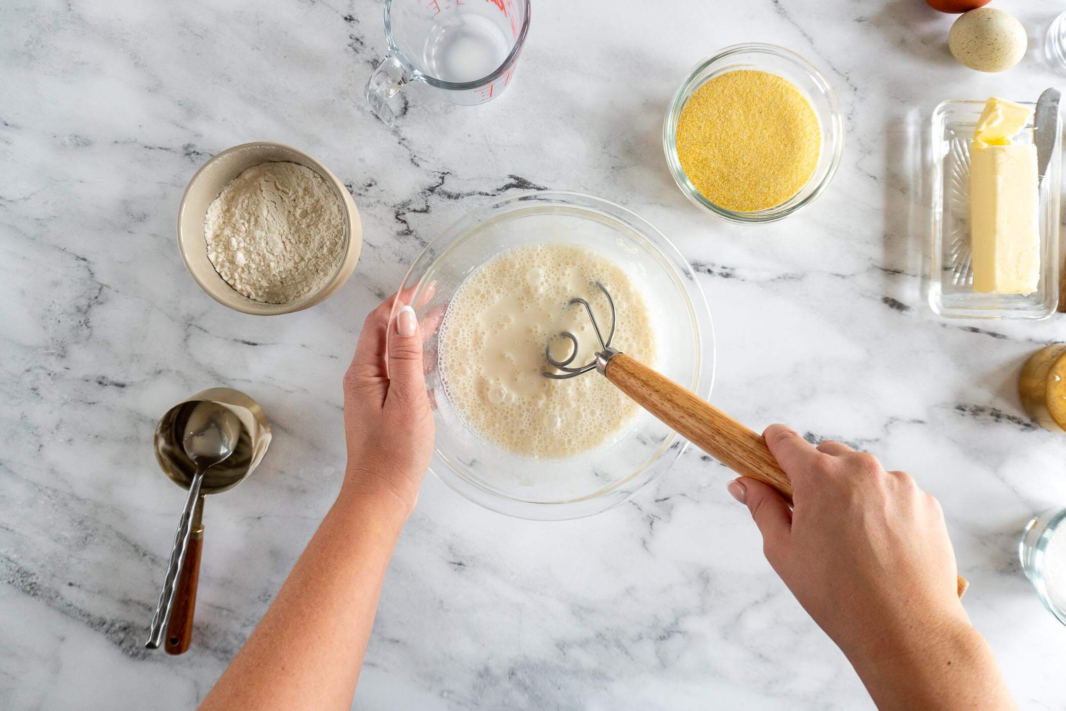 Whisking milk and sourdough discard together. 