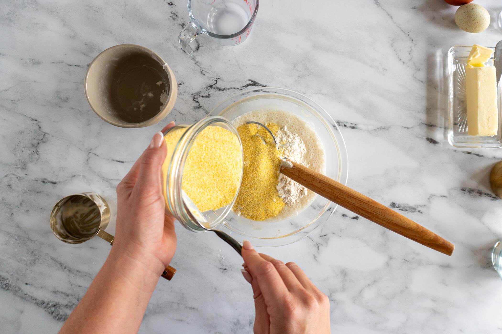Adding corn meal and flour to the discard mixture. 