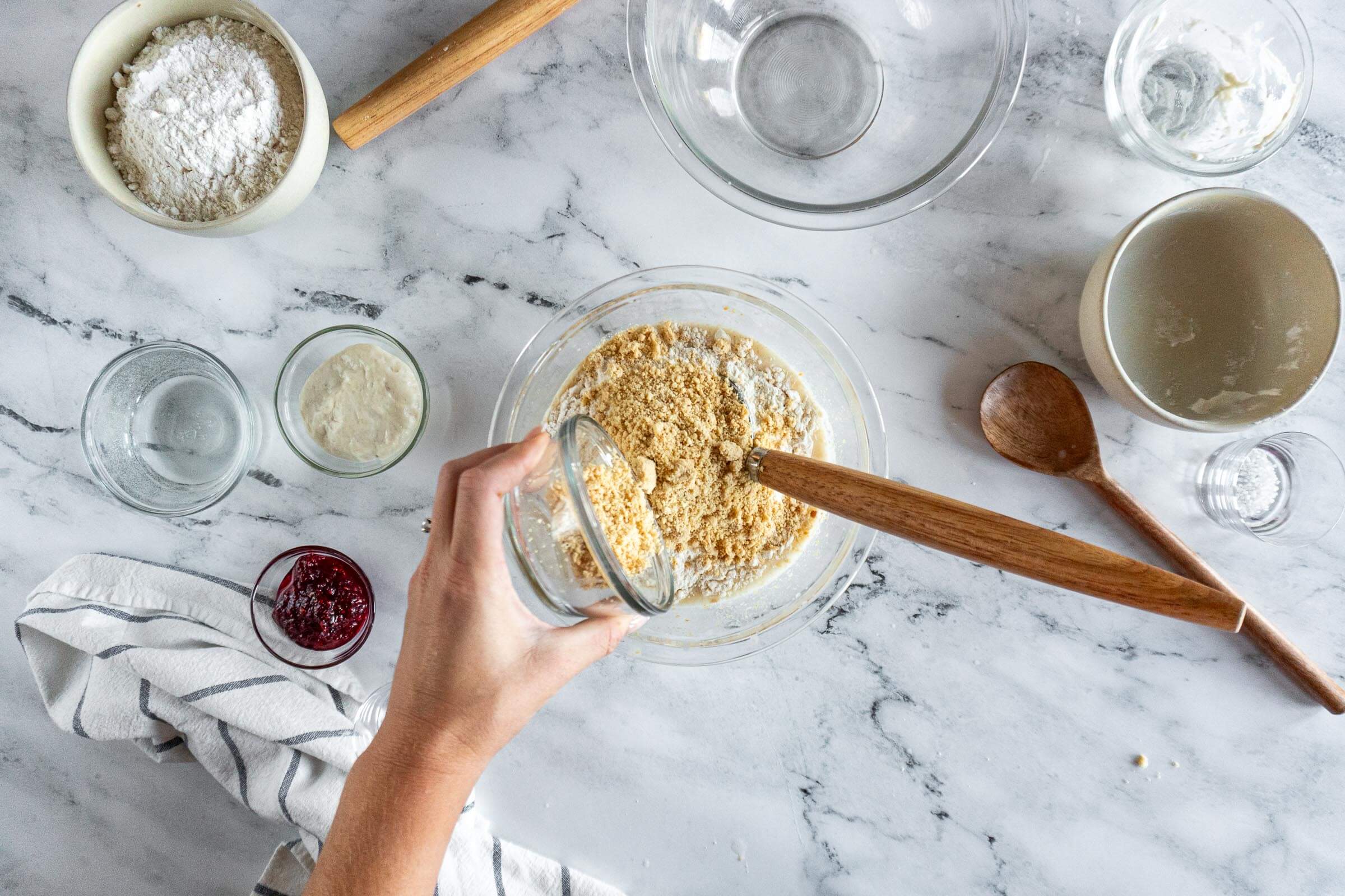 Adding ground peanuts to sourdough starter mixture. 