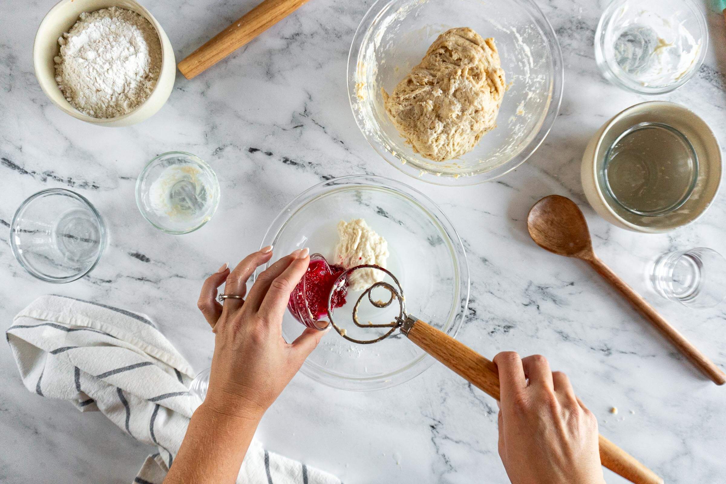 Adding jam to sourdough starter and water. 