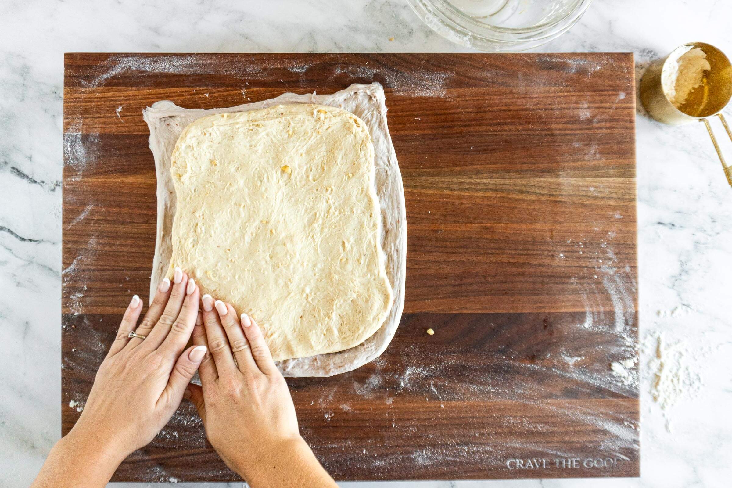 Laying the peanut butter dough on top of the jam dough. 