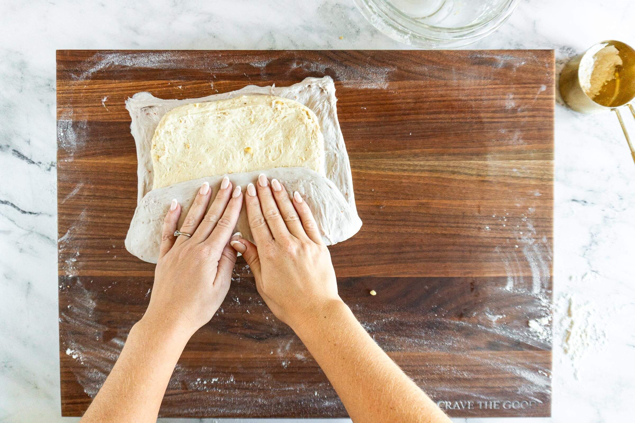 Folding up the bottom third of the dough. 