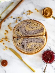 Marbled jam and peanut butter sourdough bread sliced in half.