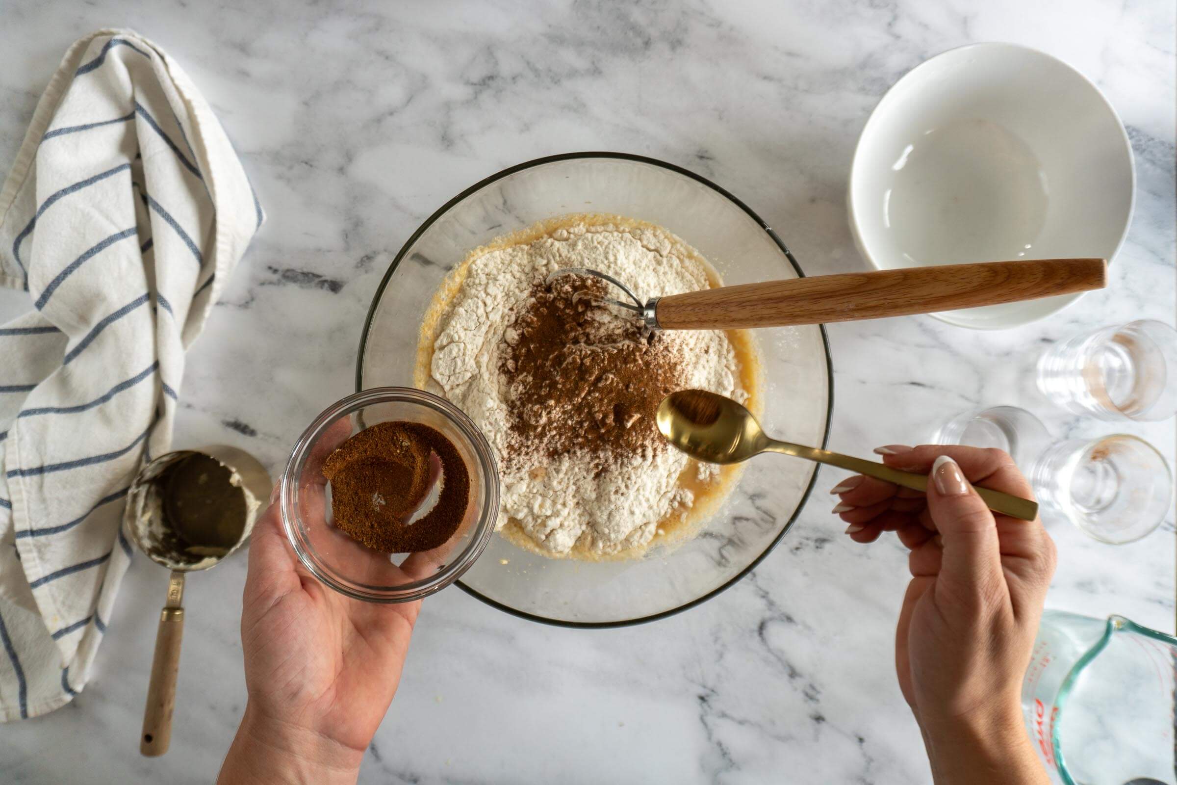 Adding half of the cinnamon spice mixture to the flour.