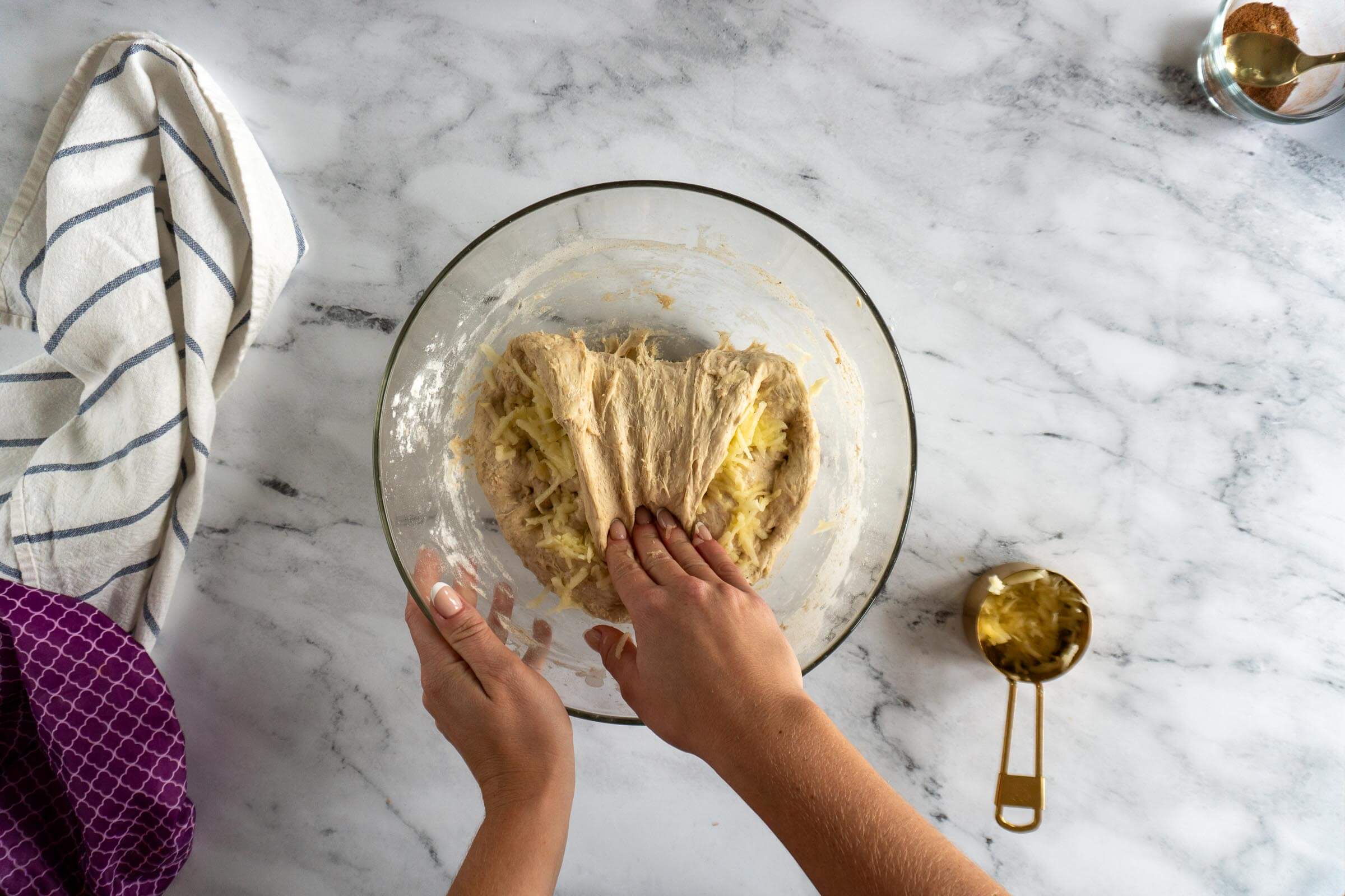 Stretching and folding the apple pieces into the sourdough dough.