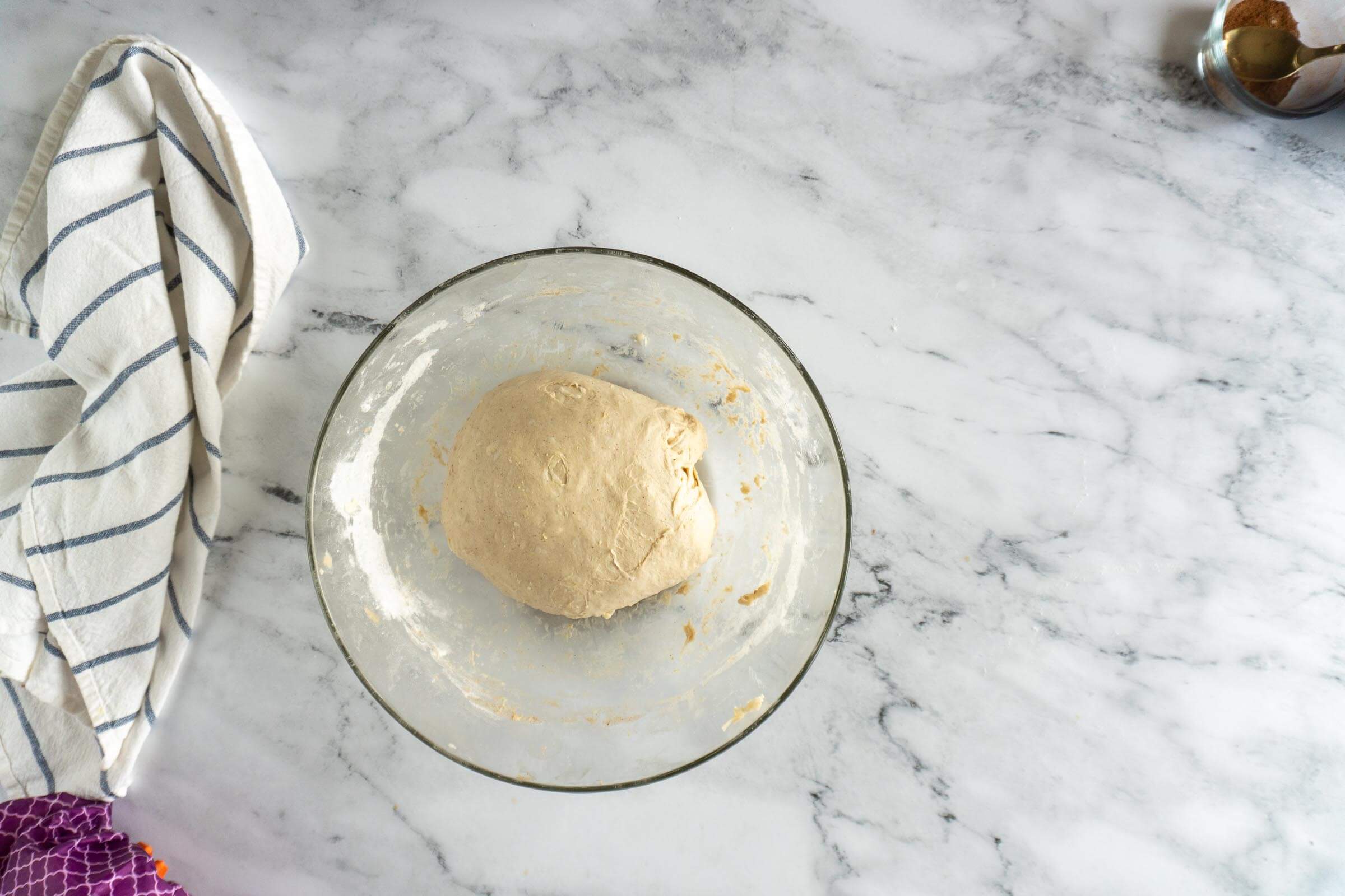Apple sourdough dough in a glass bowl before bulk ferment.