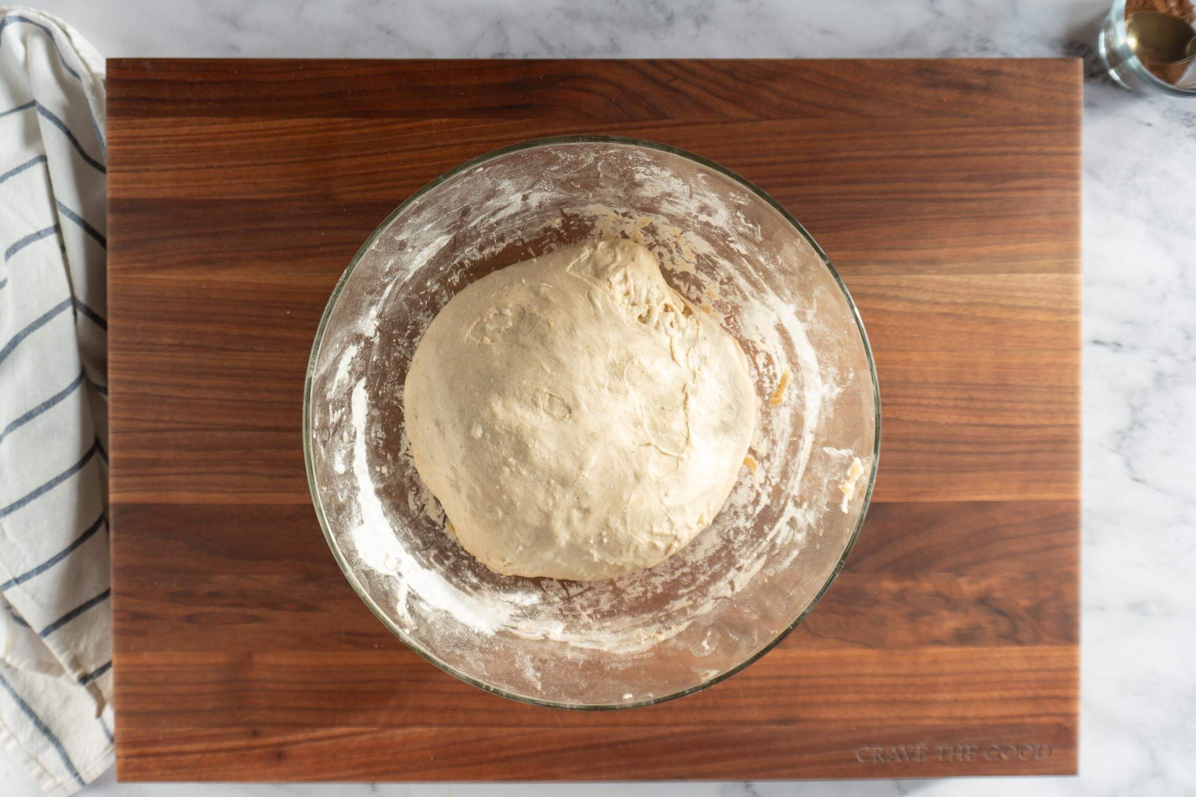 Dough in a glass bowl after bulk ferment.