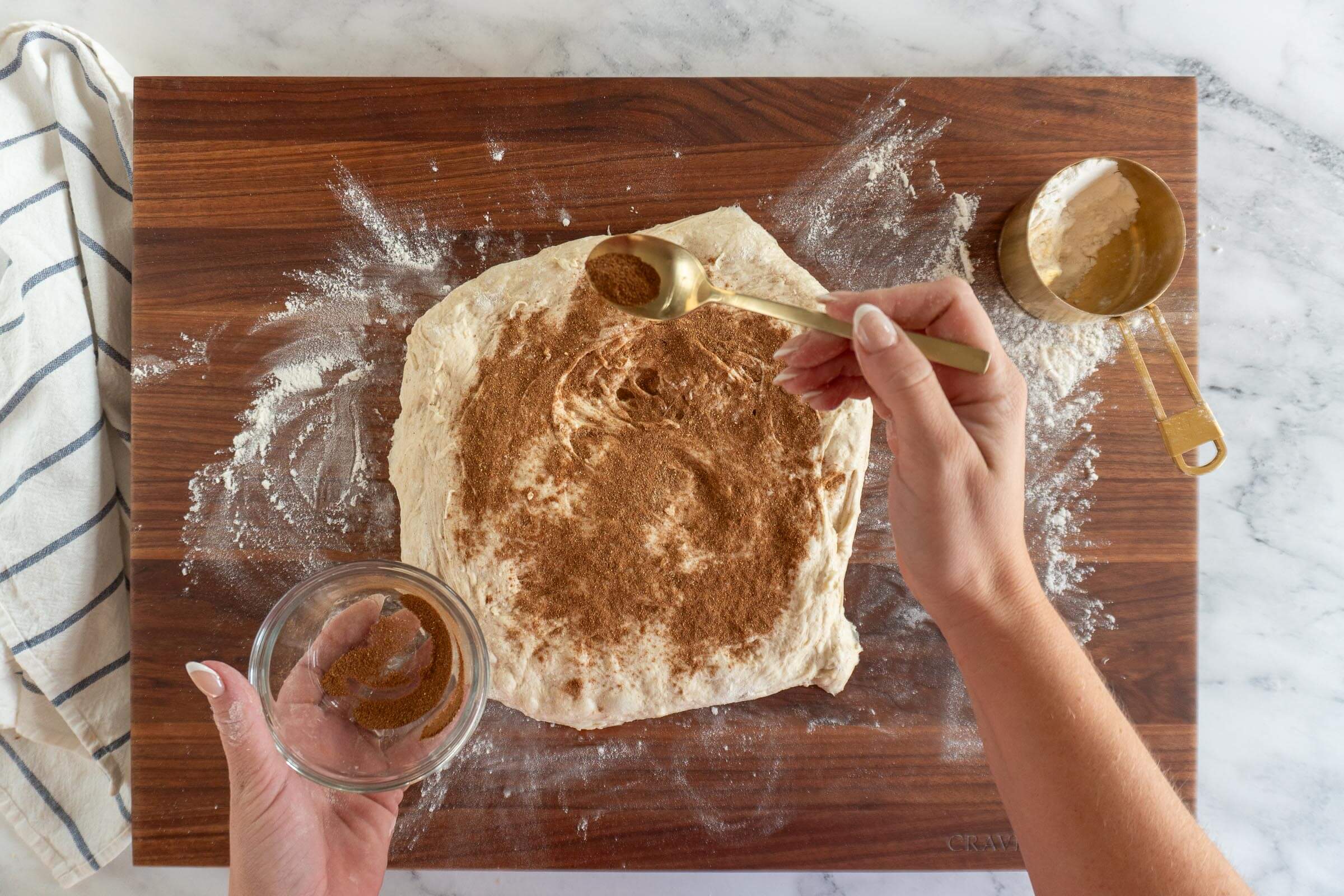 Sprinkling apple cider spice mixture over the dough.