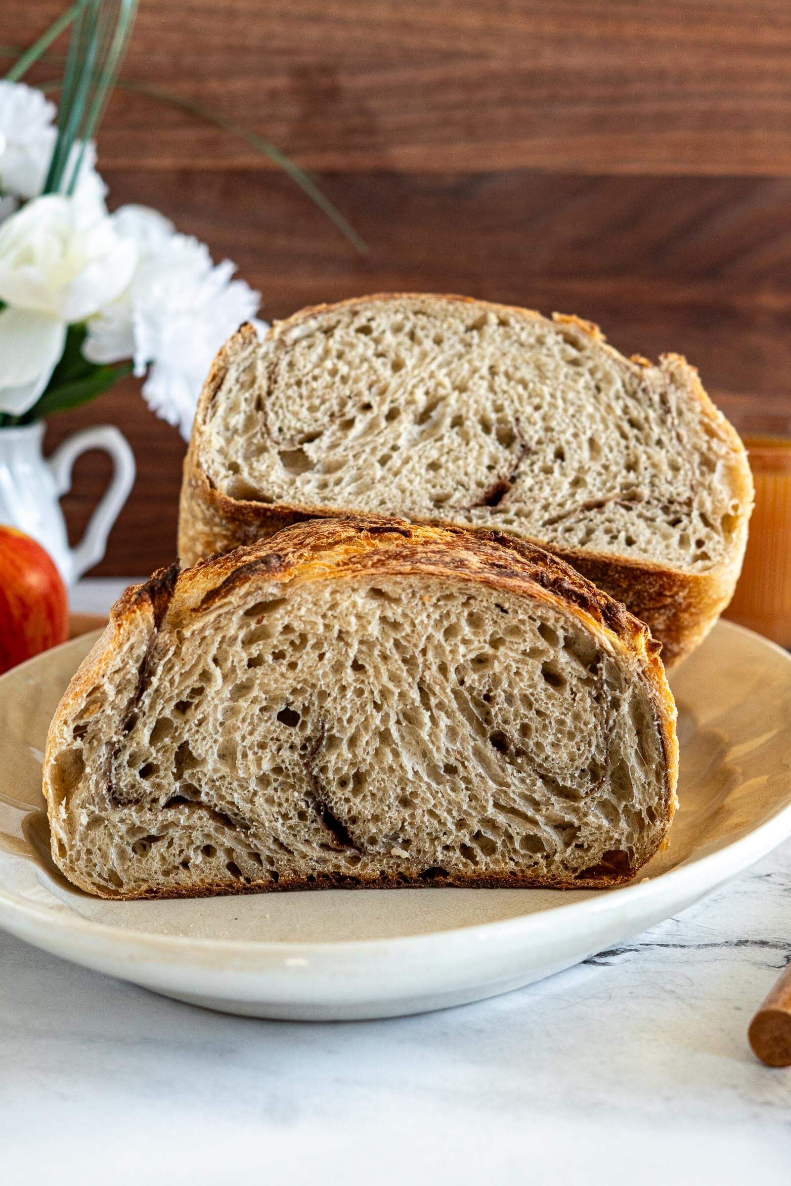 Apple cider sourdough sliced in half. Showing spice swirl.