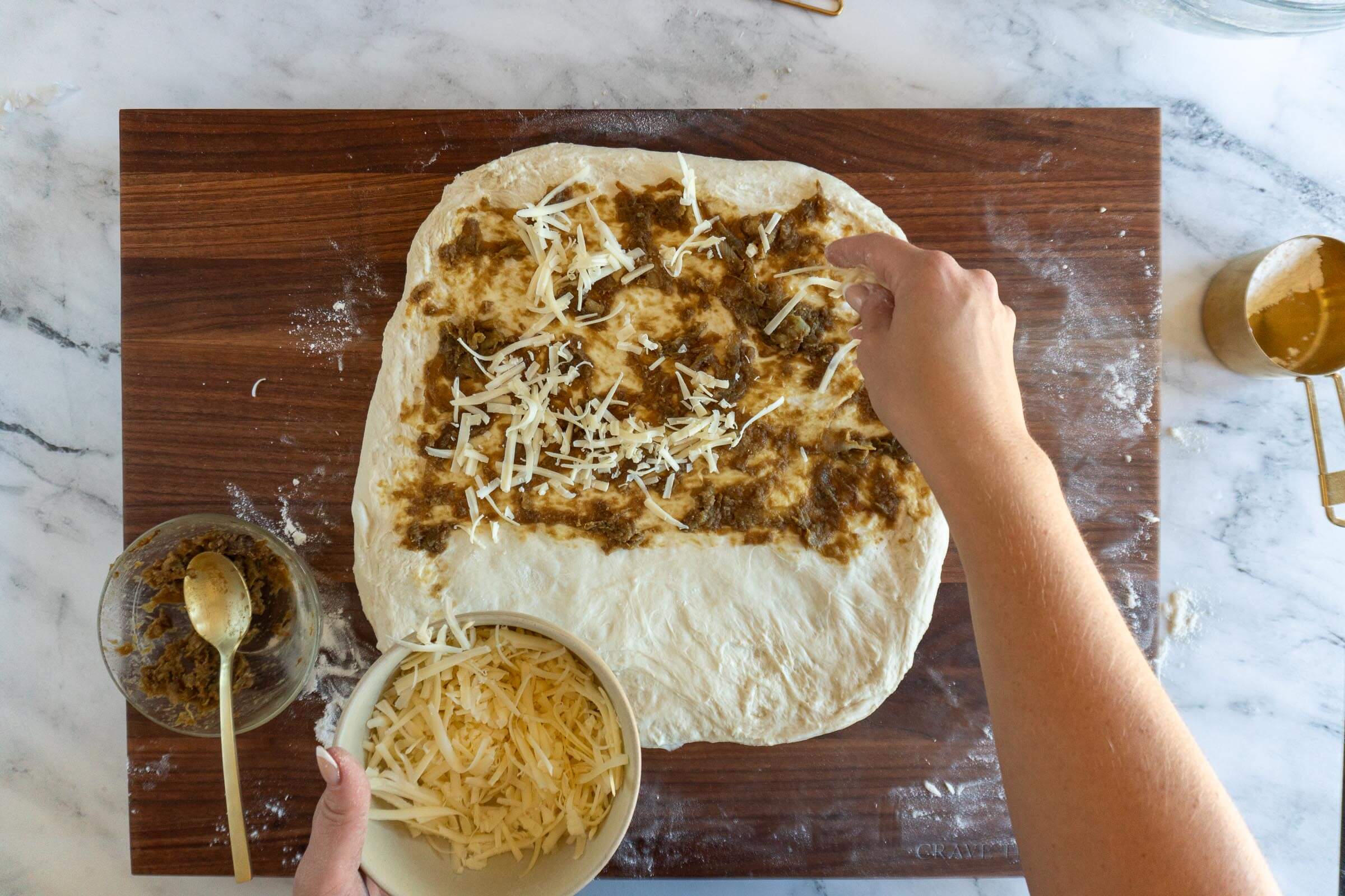 Adding shredded gouda. 