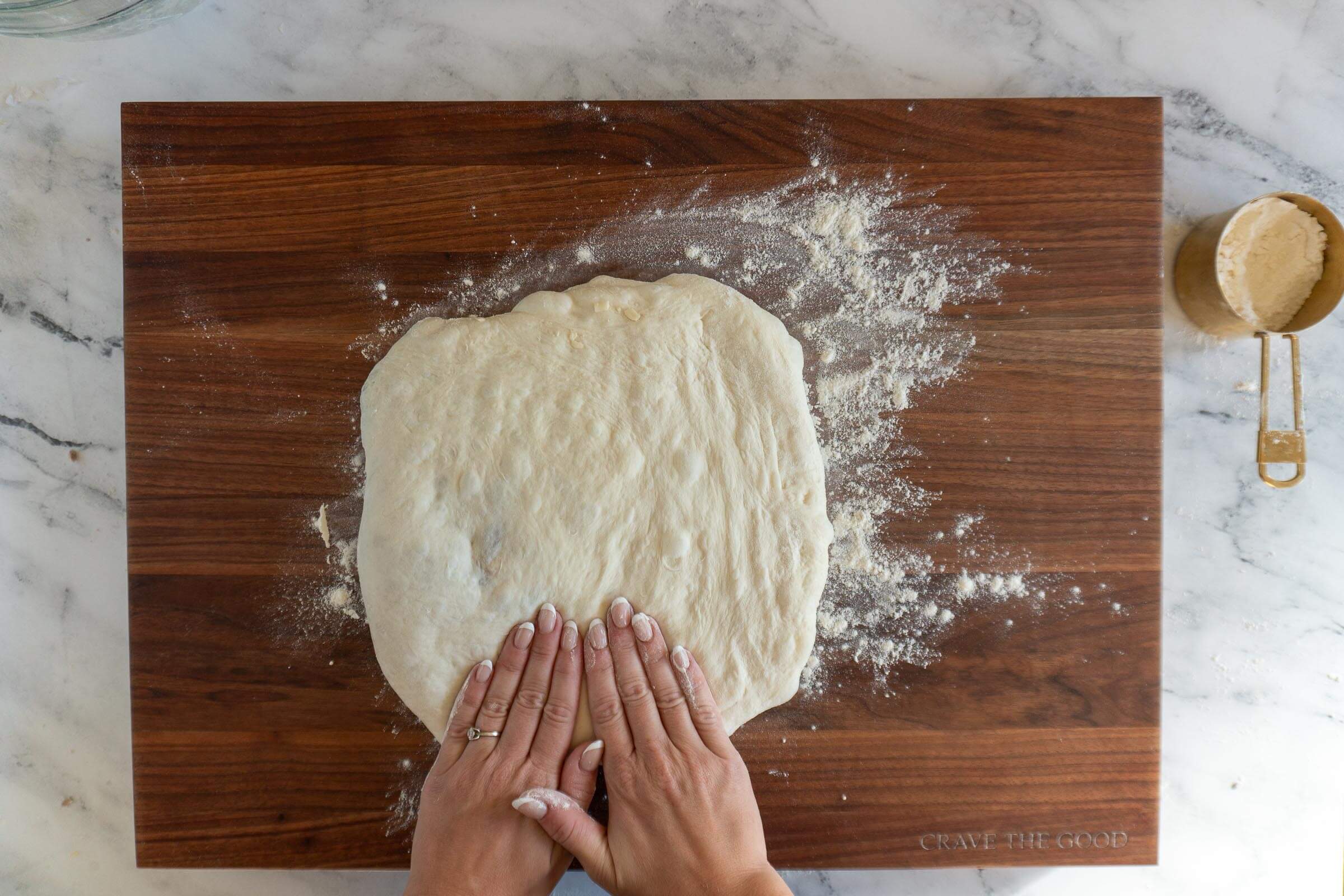 Pressing dough flat.