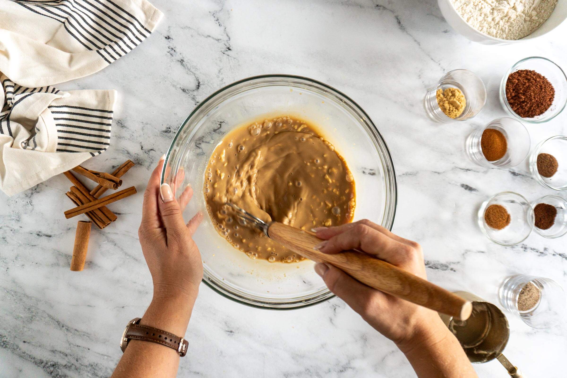 Whisking in sourdough starter with a danish dough whisk. 