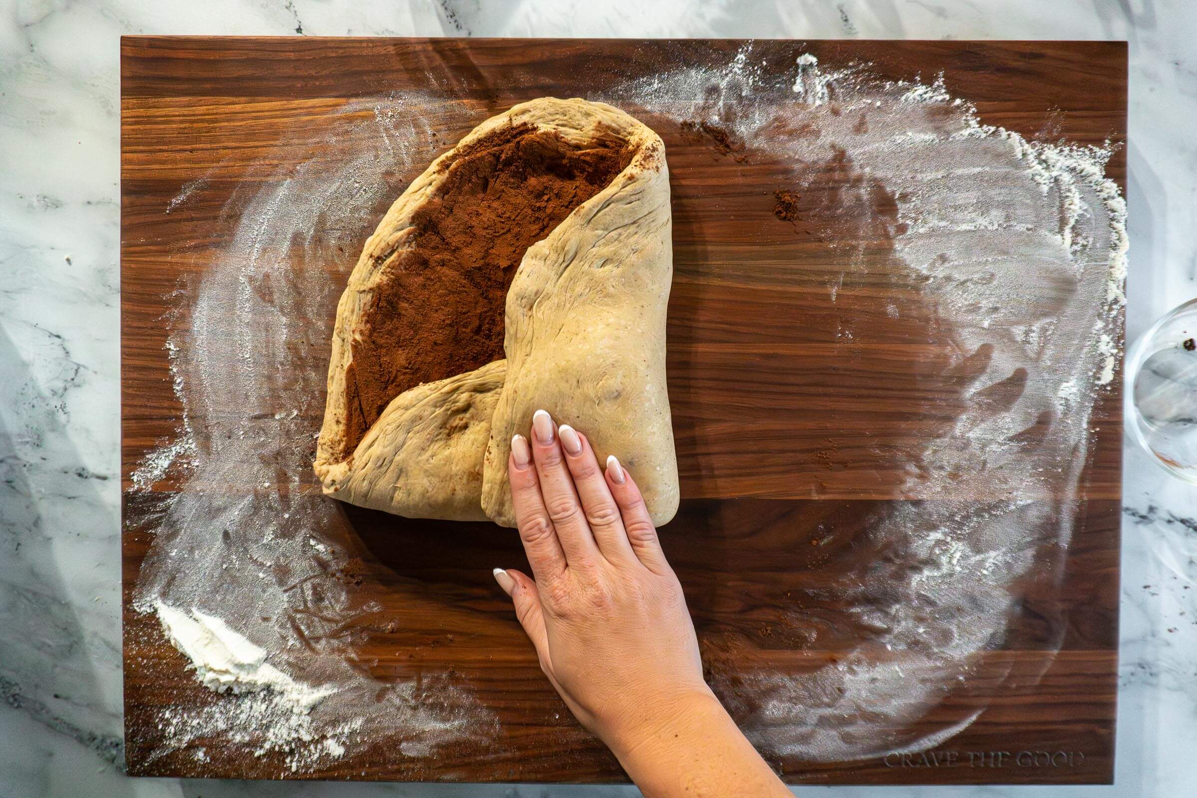 Folding in the edges of the dough. 
