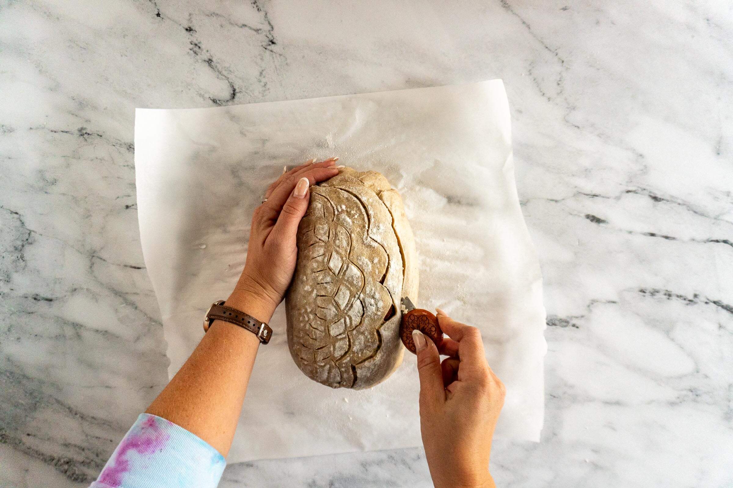 Scoring the chai latte sourdough. 