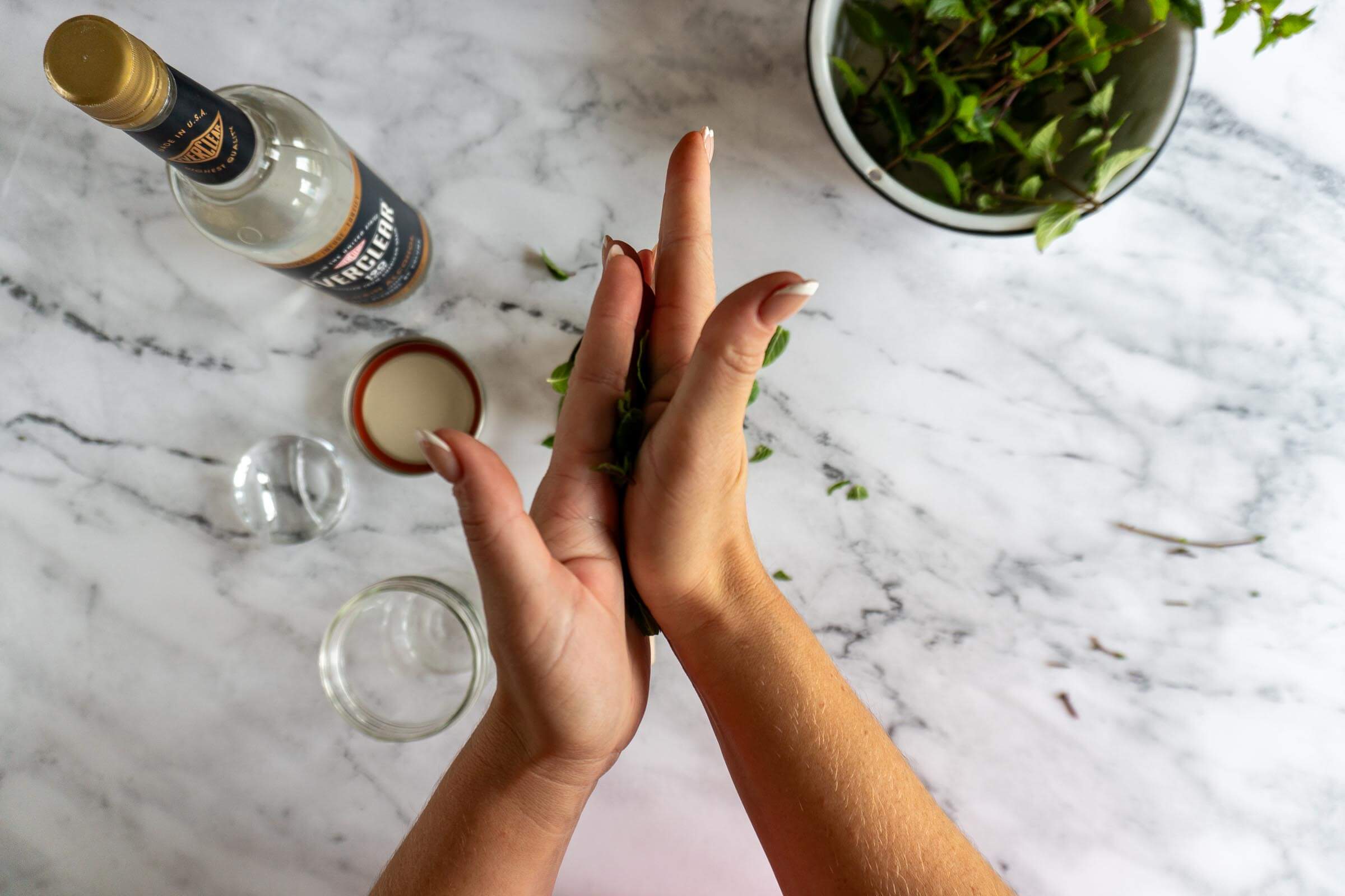 Rubbing mint leaves between hands to bruise.
